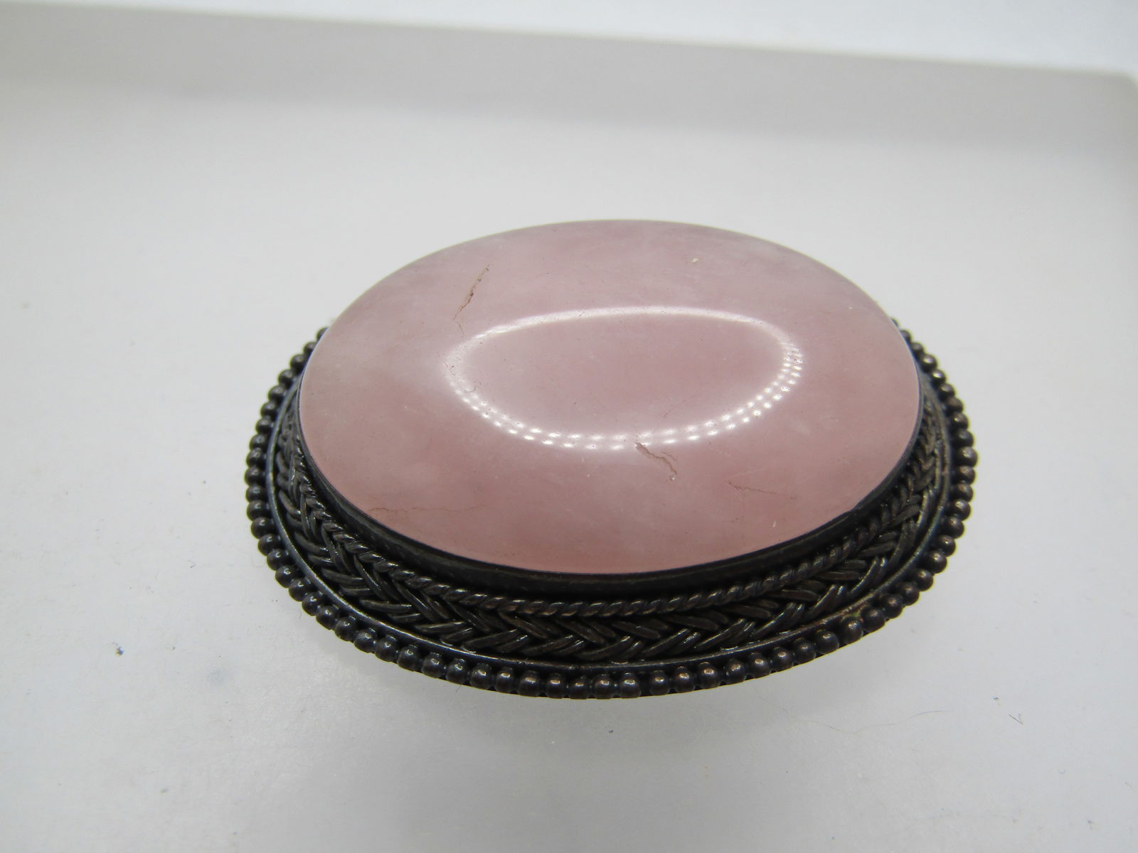 Vintage Sterling Pink Quartz Brooch, 1950's-1960's: Vintage Sterling Pink Quartz Brooch, 1950's-1960's. This has an oval 31mm by 22.5mm pink quartz that is bezel-set with a frame that tapers downward and widens with beaded, rope and criss-cross accents
