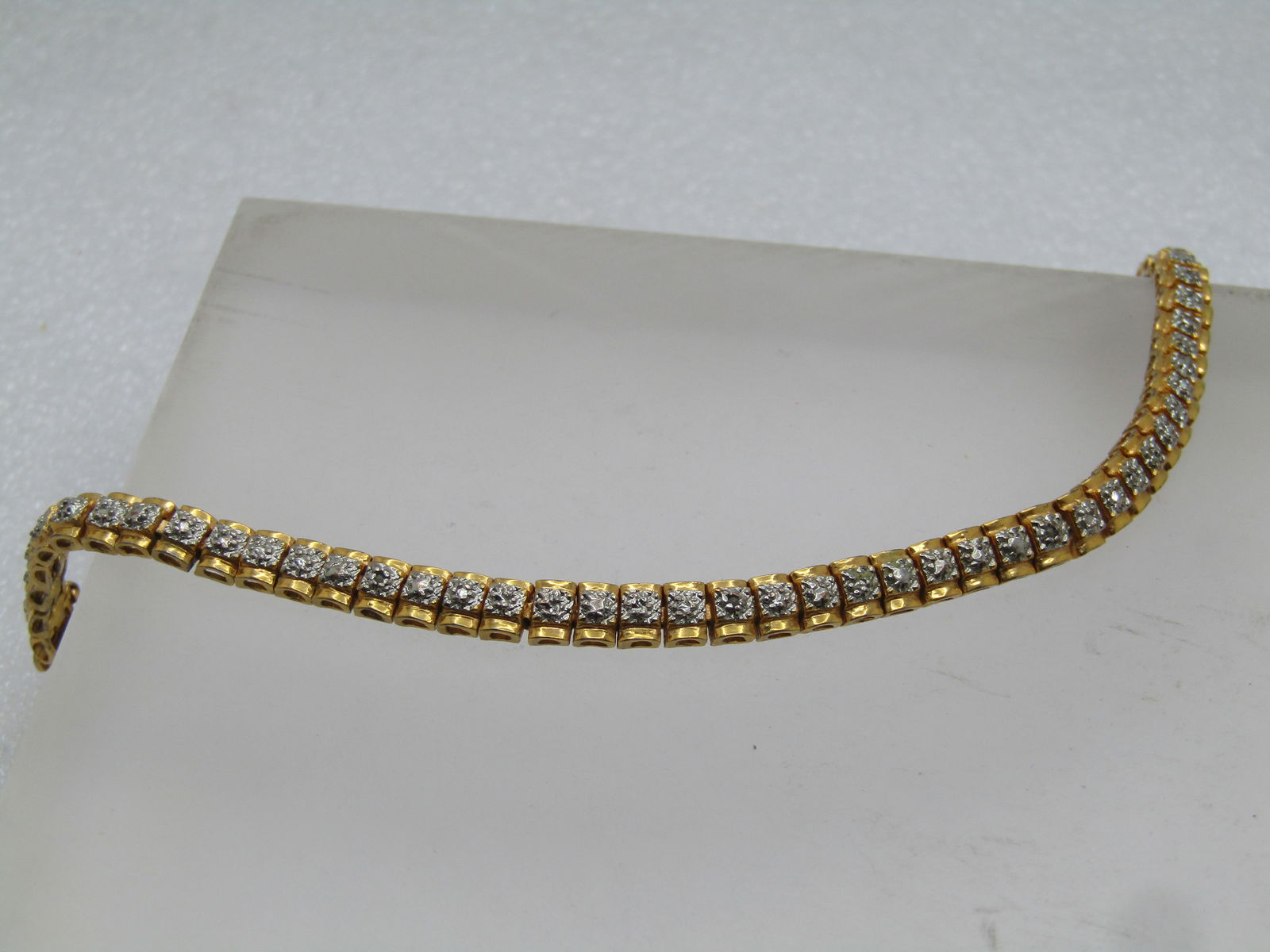 Vintage Sterling Goldwashed Illusion Tennis Bracelet 7", 1980's-1990's: Vintage Sterling Goldwashed Illusion Tennis Bracelet 7", 1980's-1990's. Marked sterling and test as sterling with a weight of appx. 11.35 gr. It is 7" long with yellow gold wash over the links and a s