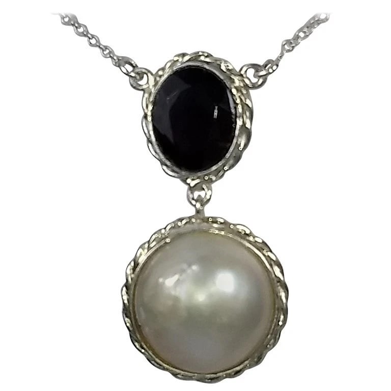 Alberto Juan Mexican Handmade Sterling Silver Mabe Pearl and Red Garnet Necklace: Title:Alberto Juan Mexican Handmade Sterling Silver Mabe Pearl and Red Garnet NecklaceDescription:This Alberto Juan one of a kind necklace was handmade from sterling silver, oval faceted red garnet