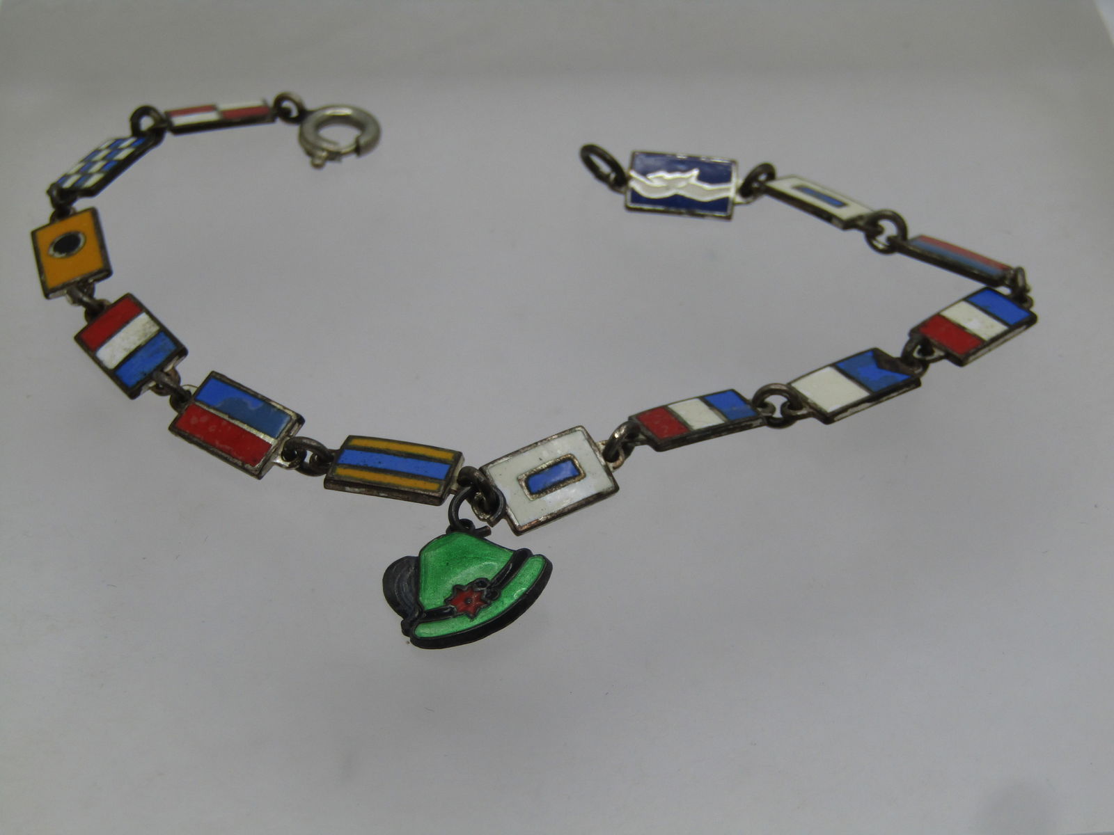 Vintage .835 German Enameled Flag Bracelet, 1950's, 7.25": Vintage .835 German Enameled Flag Bragelet, 1950's, 7.25". The flags are believed to be flags associated with WW-II or post WW-II relevance. The bracelet has enameled flags that are rectangular and