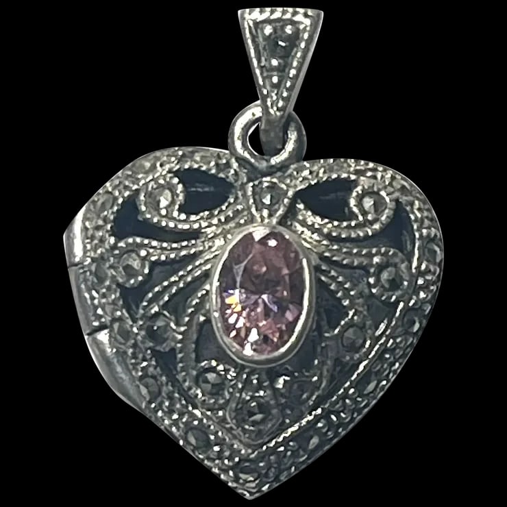 Vintage Sterling Silver Marcasite Heart Locket with Pink Oval Stone: Title: Vintage Sterling Silver Marcasite Heart Locket with Pink Oval Stone Description: Vintage Sterling Silver Marcasite Heart Locket with Pink Oval StoneSterling Silver, MarcasiteWeighs 5.4 gramsMea