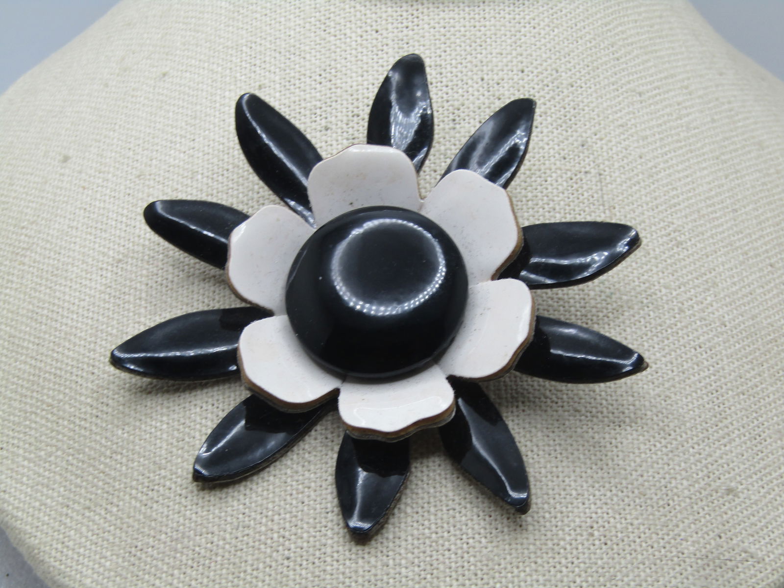 Vintage Black & White Blossom Brooch, 1950's-1960's, 3.25": Vintage Black & White Blossom Brooch, 1950's-1960's, 3.25". Black daisy type petals on the lower level with shorter and wider white petals around the 1.25" black slightly domed center of the