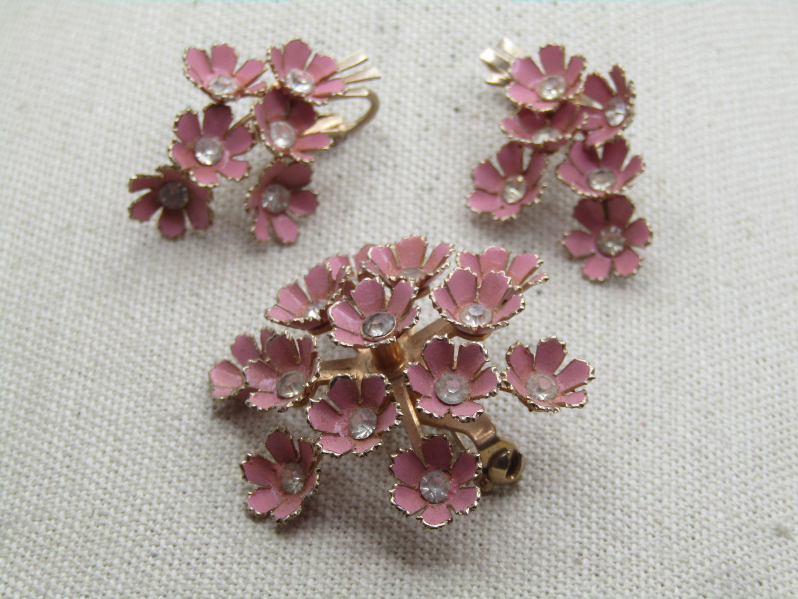 Vintage Pink Enameled Forget-Me-Not Brooch & Earrings, Clip, 1950's-1960's: Vintage Pink Enameled Forget-Me-Not Brooch & Earrings, Clip, 1950's-1960's. Pink blossoms with a recessed center that have a clear rhinestone int he center. Each blossom is appx. 1/3" across. It is a