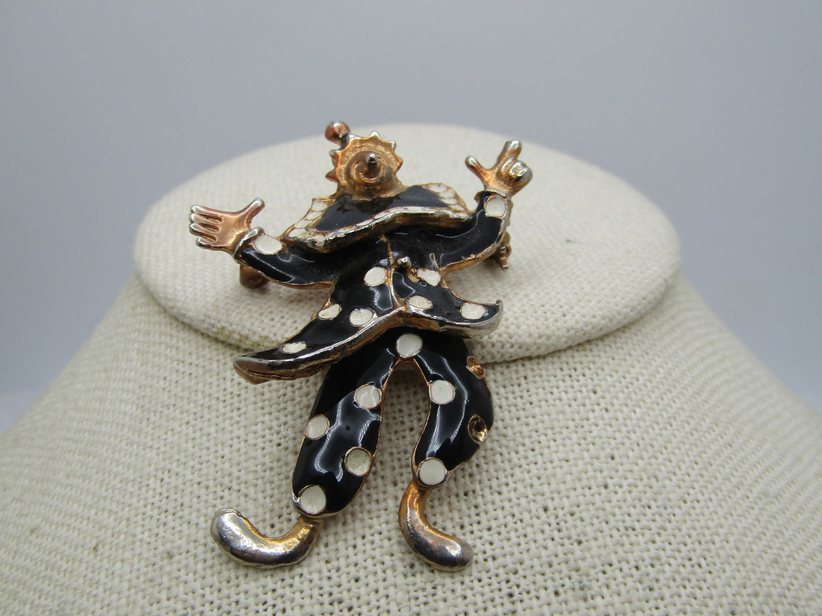 Vintage Black & White Enameled Clown Brooch, Articulated. 1950's-1960's: Vintage Black & White Enameled Clown Brooch, Articulated. 1950's-1960's. This swivels at the hips with a flowing top with wide collar, black enameled with white enameled dots. It is 2.25" tall and