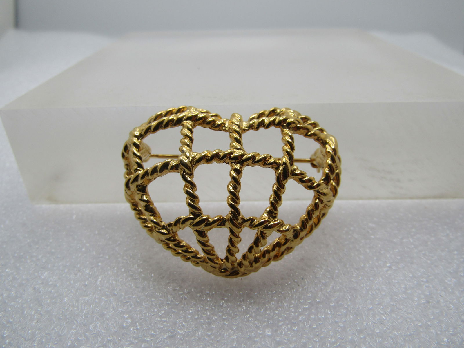 Vintage Open Grid Heart Brooch, Signed AK, 1980-'s-1990's.: Vintage Open Grid Heart Brooch, Signed AK, 1980's-1990's. Anne Klein. . Gold tone with a rope accent highly domed domed grid in the shape of a heart. The brooch has a locking clasp. It is appx. 1.25"