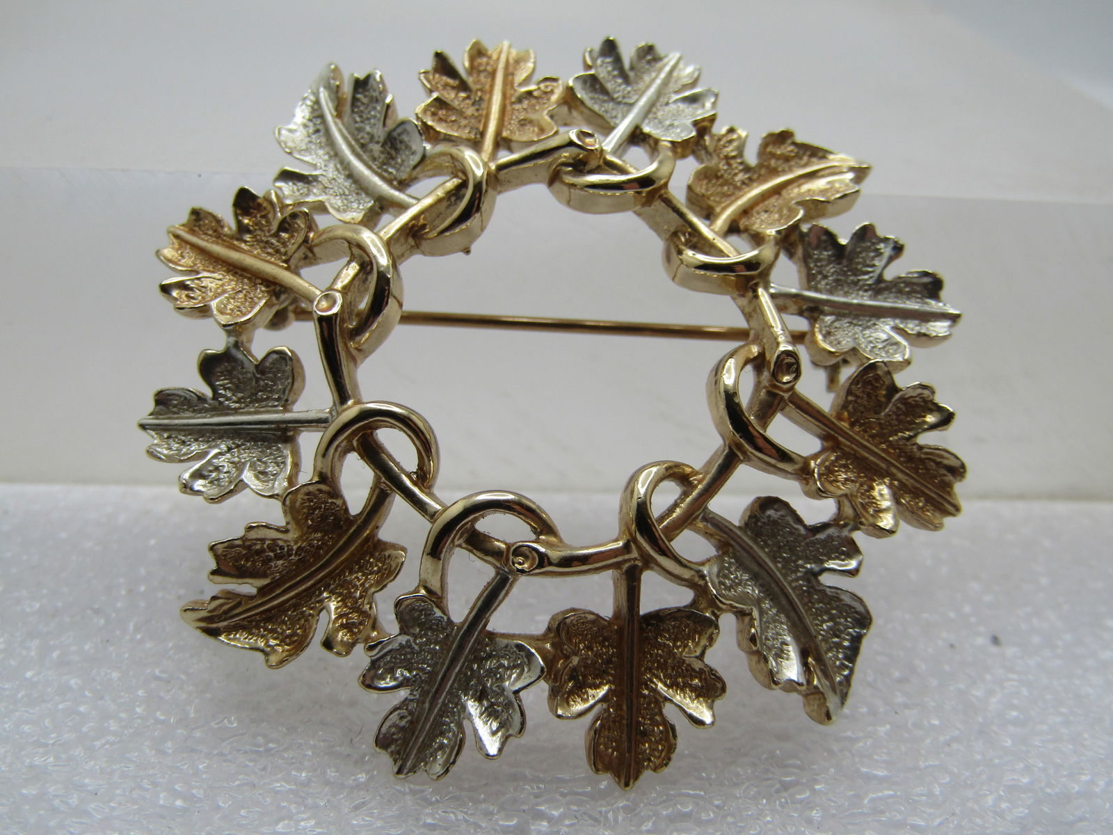Vintage Two Tone Leaf Circle Brooch, 1960's-1970's, Sarah Coventry: Vintage Two Tone Leaf Circle Brooch, 1960's-1970's, Sarah Coventry. It is gold tone and silver tone and appx. 2" wide with open center and the stems of the eles wrapping around the centr circle. 