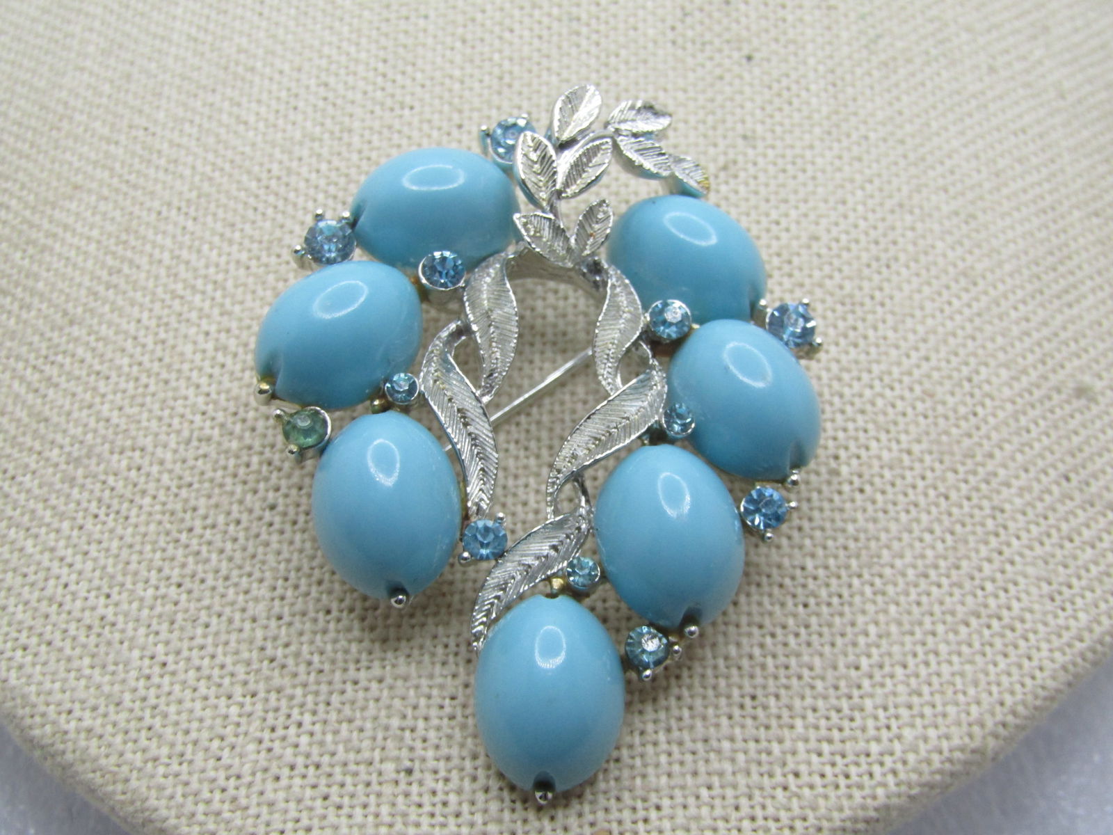 Vintage Leaf Fine Brooch, Tuquoise Plastic & Glass Rhinestones, Signed Lisner 1960's: Vintage Leaf Fine Brooch, Tuquoise Plastic & Glass Rhinestones, Signed Lisner 1960's. Plastic egg shaped cabochons in pale blue plastic that are appx. 12.5mm by 10mm. There are 3mm and 2.5mm light