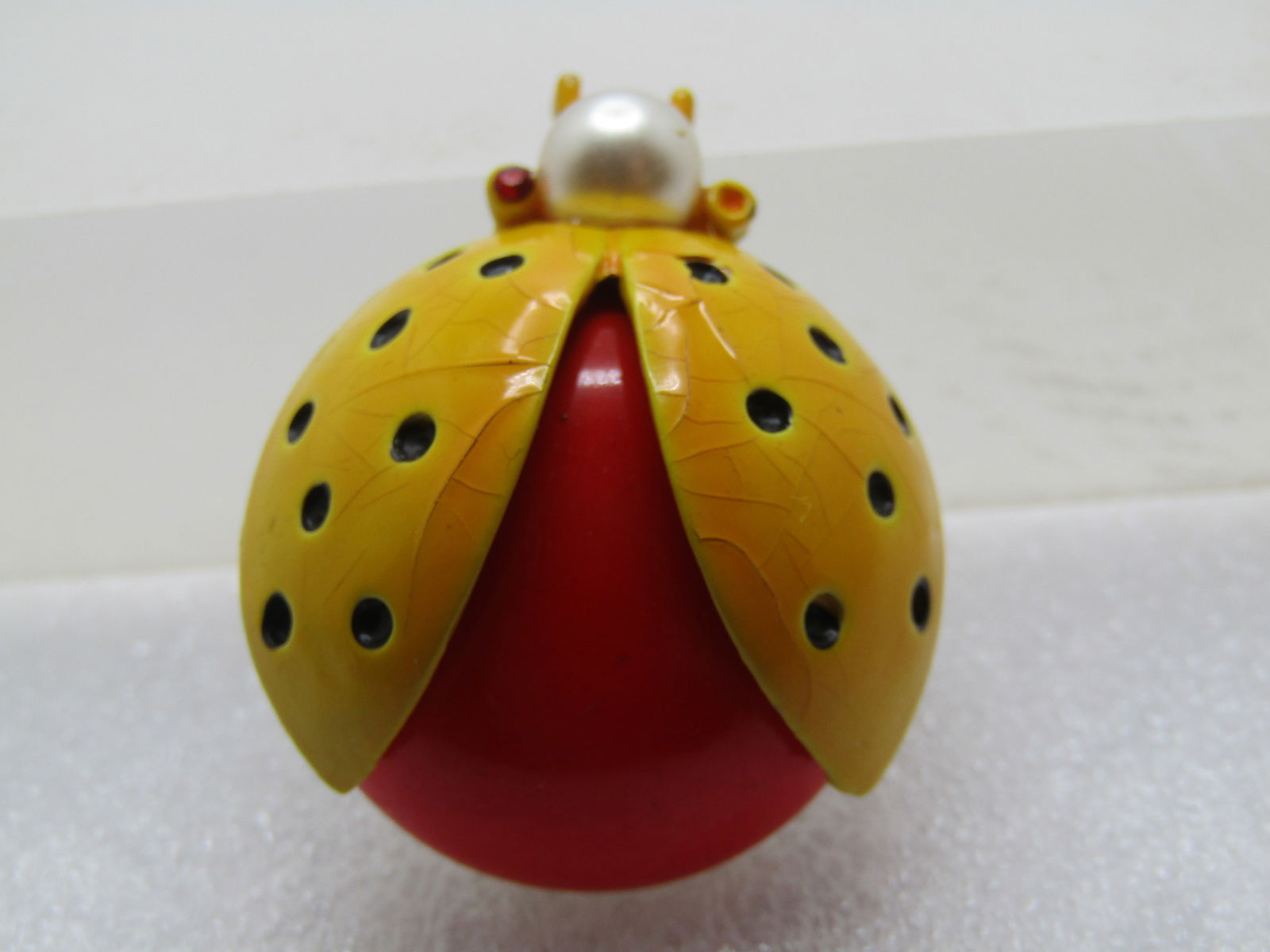 Vintage Enameled Lady Bug/Beetle Brooch, Signed Capri, 1950's: Vintage Enameled Lady Bug/Beetle Brooch, Signed Capri, 1950's Yellow enameled wings with black dots and a domed orange body under the wings with an 8mm faux pearl head and rhinestone orange/red
