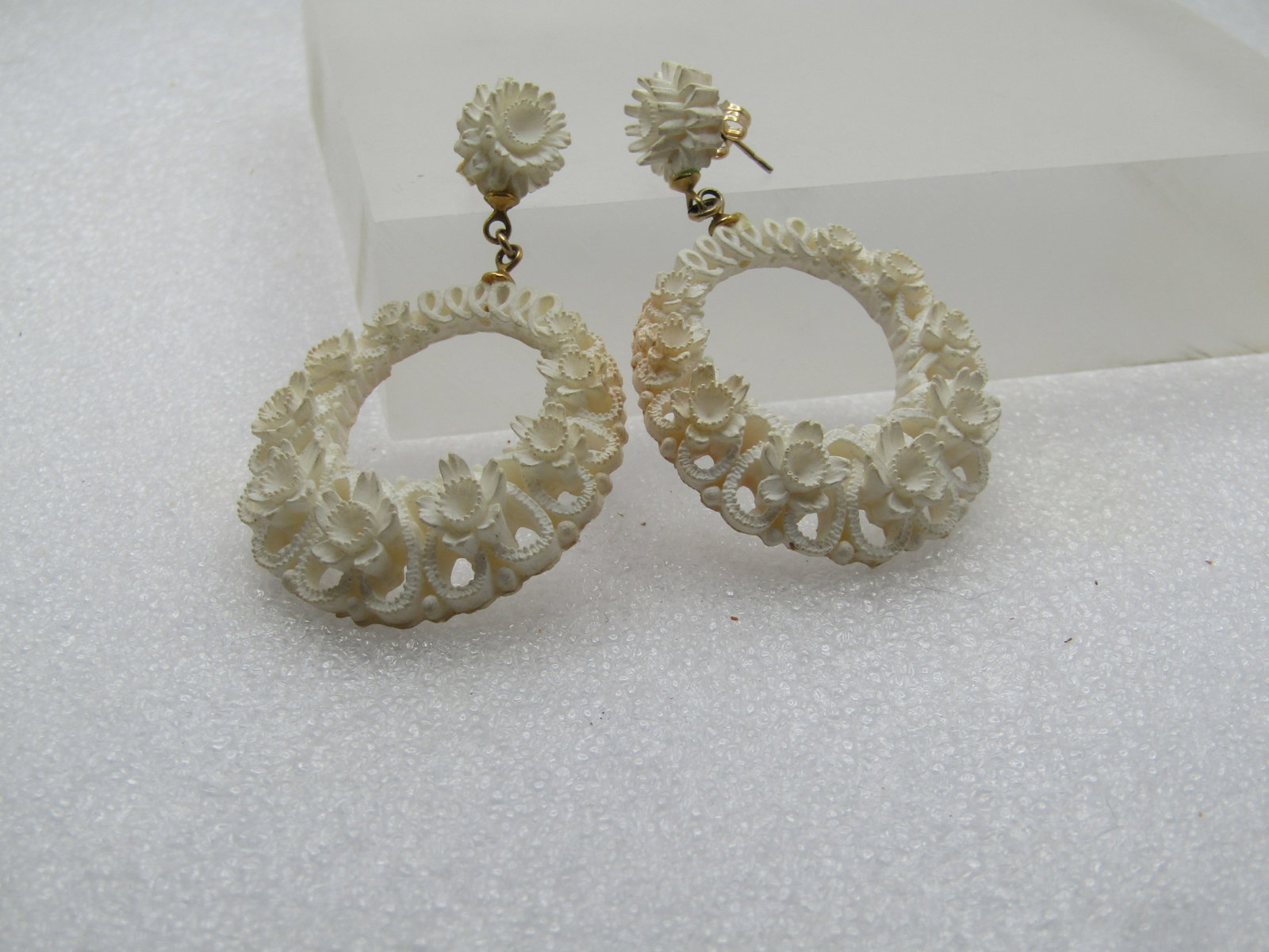 Vintage White Floral Earrings, Stud & Hoop, 1960's-1970's, Pierced: Vintage White Floral Earrings, Stud & Hoop, 1960's-1970's, Pierced. White molded with a blossom stud and a tapered round drop that has blossoms around most of the hoop. The earrings are appx. 2.25"
