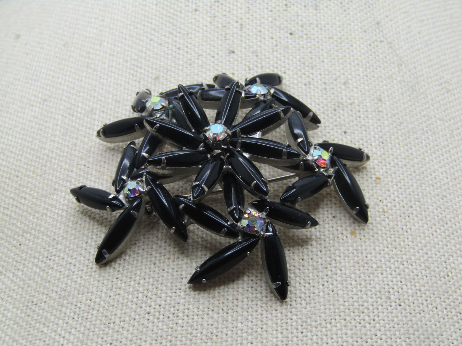 Vintage Black & Clear Domed Blossom Brooch, 1950's-1960's, Aurora Borealis, 2.5": Vintage Black & Clear Domed Blossom Brooch, 1950's-1960's, Aurora Borealis, 2.5". Six total blossoms with five making up the lowest tier with four black glass navette petals that are appx. 14.5mm by