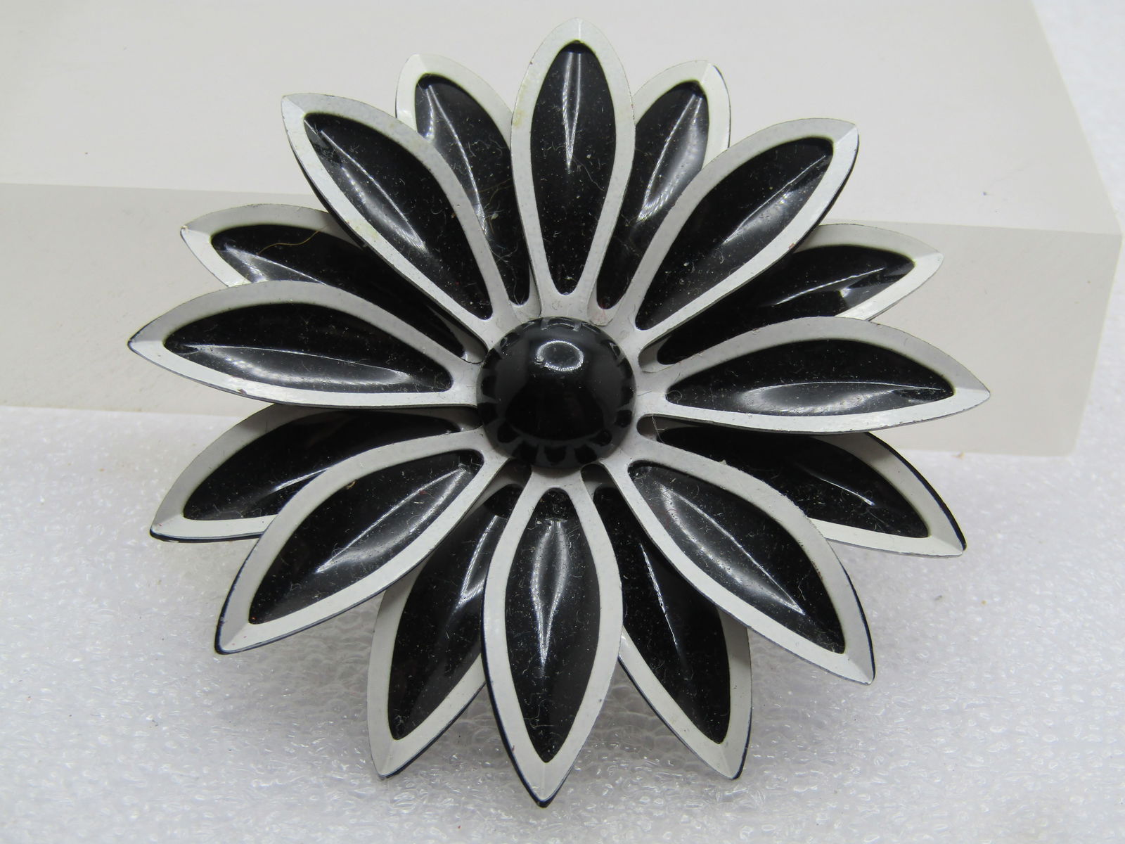 Vintage Black & White Blossom Brooch, 1960's, 2.5": Vintage Black & White Blossom Brooch, 1960's, 2.5". Pinted black enameled petals arranged in two tiers with white enameled outlines to each petal and a black enameled round and domed center that is