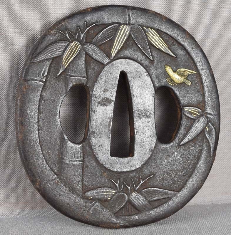 18c Japanese sword TSUBA bird & bamboo: 18th to early 19th century iron Japanese sword tsuba depicting a bird in flight among bamboo stems and leaves with design continuing on the back. Wonderful subject, crisp work with gilding, excellent