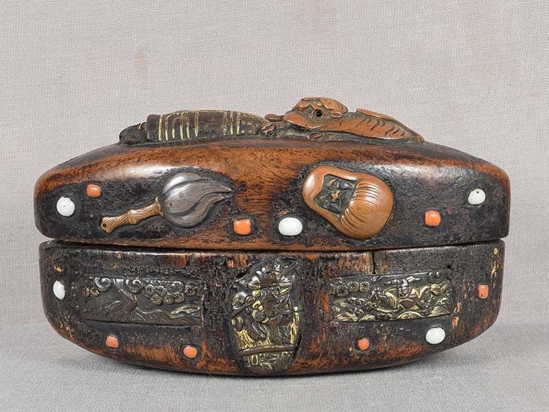 Early 19c TONKOTSU (netsuke box) TIGER Daruma, animals: Early 19th century tonkotsu ( a form of into with one compartment), its sides and top inlaid with various metal parts of sword furniture (menuki, fuchi and kashira) as well as coral and glass. Images