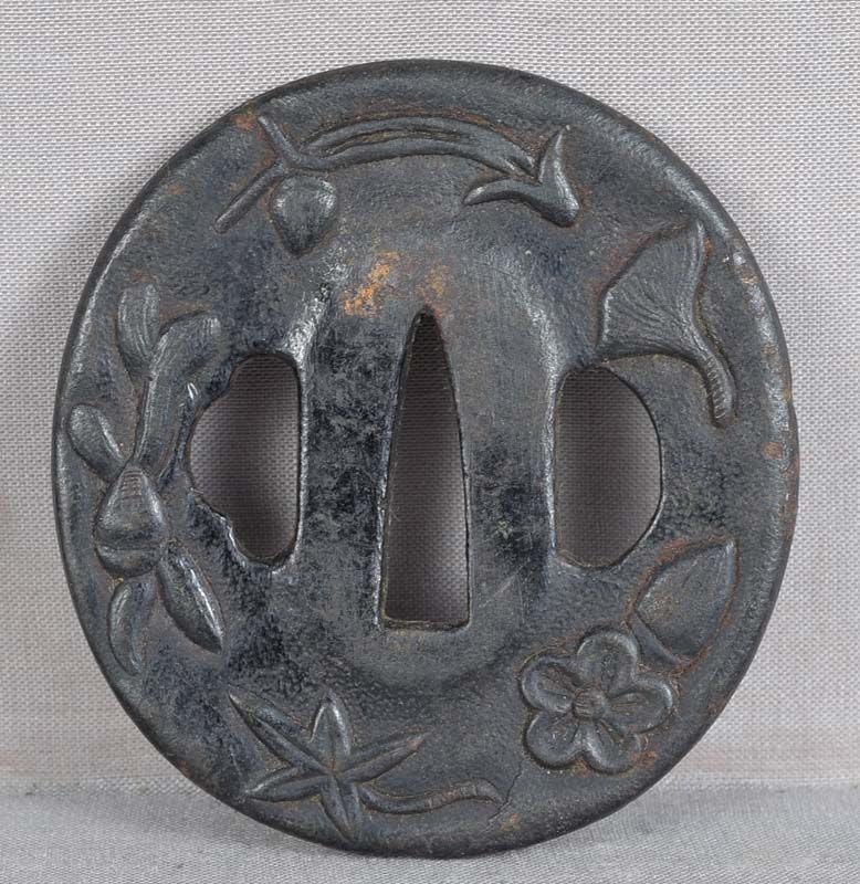 18c Japanese sword TSUBA forest items: Late 18th to early century Japanese sword tsuba with relief decoration of all sorts of natural objects, including ginkgo nuts and leaves, pine needles and cones, mushrooms, cherry flowers, maple