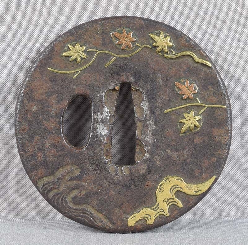 18c Japanese sword TSUBA maple leaves: 18th to early 19th century iron Japanese sword tsuba inlaid with branches of maple tree with leaves turning yellow and red, roots and cresting waves below, design continuing on the back . Wonderful
