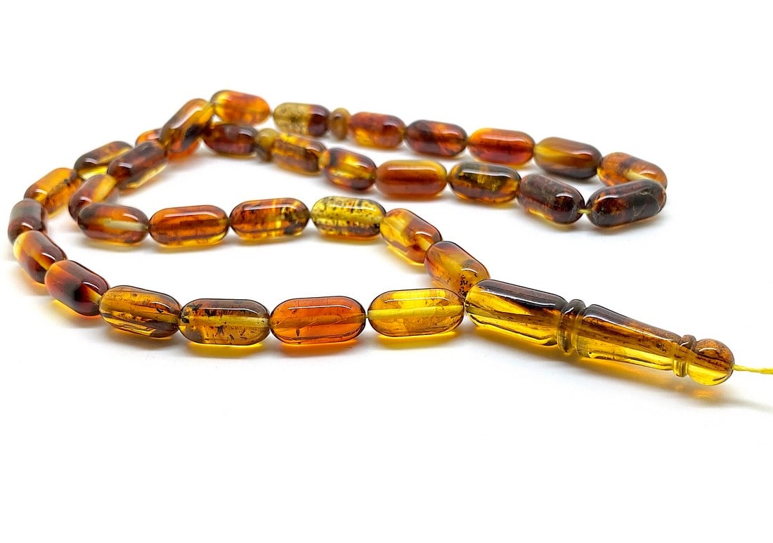 Amber Tesbih made from Barrel tablet shaped Amber beads: Title:Amber Tesbih made from Barrel tablet shaped Amber beads Metal:None Gemstone:Amber Weight:25.8 g Size:Bead size: 16.0 x 8.0 mm Bead size: 0.63 x 0.315 inches Made of:(Reconstituted Amber or Whole