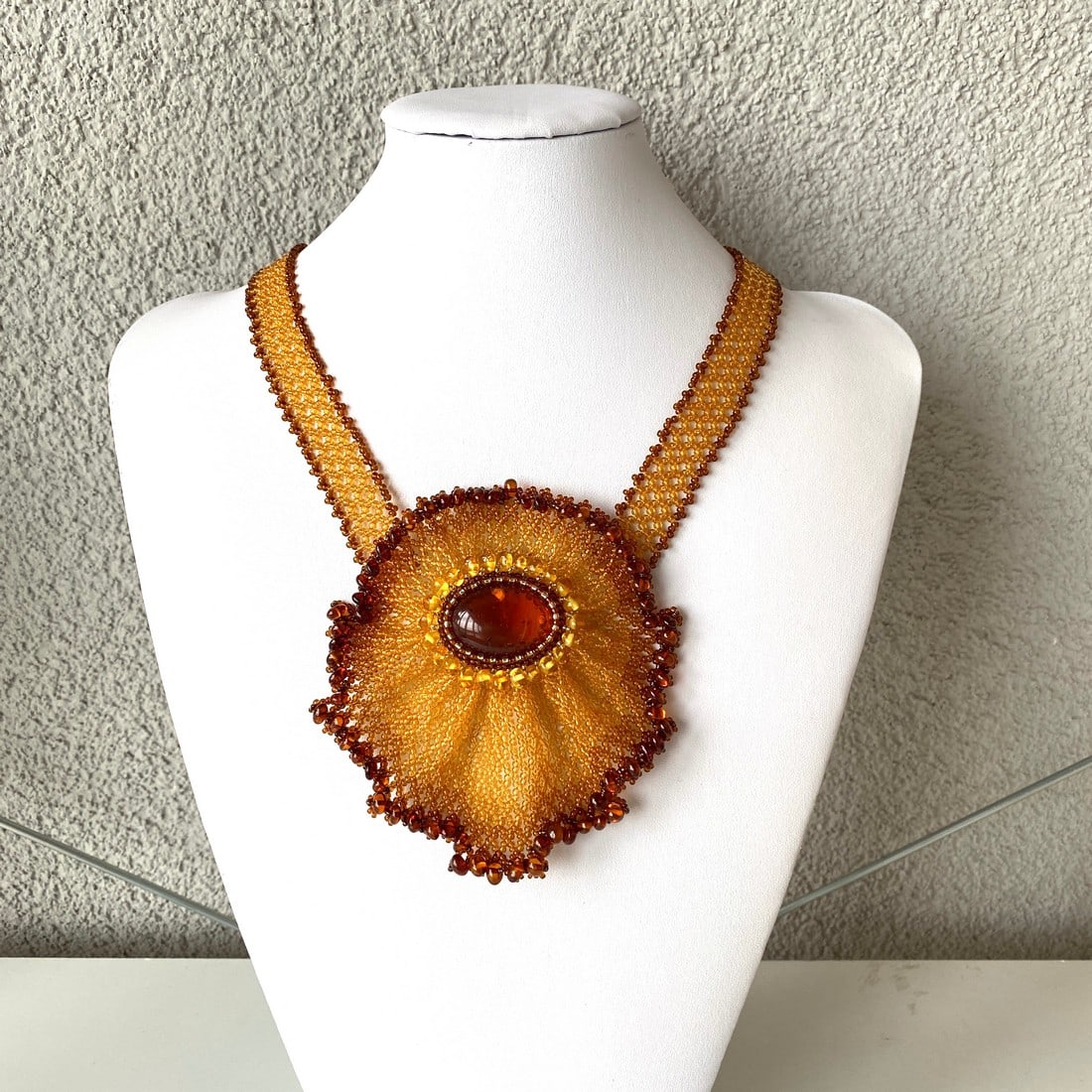 Unique and Alluring Amber Floral Necklace made from leaf like bead ornaments: Title:Unique and Alluring Amber Floral Necklace made from leaf like bead ornaments Metal:NoneGemstone:AmberWeight:55.6 gSize:Size: 107.0 x 12.0 x 500.0 mm Size: 4.213 x 0.472 x 19.685 inches Made