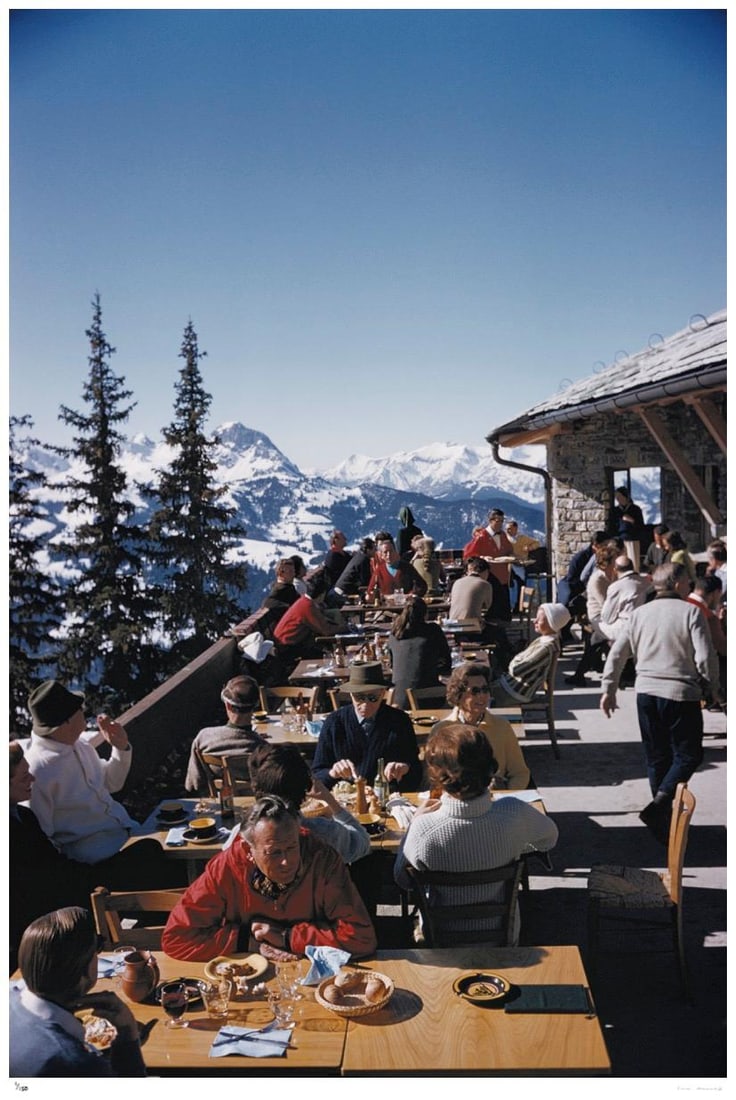 Dining In Gstaad 1961 - Slim Aarons Estate Stamped: 1961 (printed later): Title: Dining In Gstaad 1961 - Slim Aarons Estate Stamped: 1961 (printed later) Description: Dining In Gstaad 1961 - Slim Aarons Estate Stamped Holidaymakers at a ski lodge at Gstaad, Switzerland, Mar