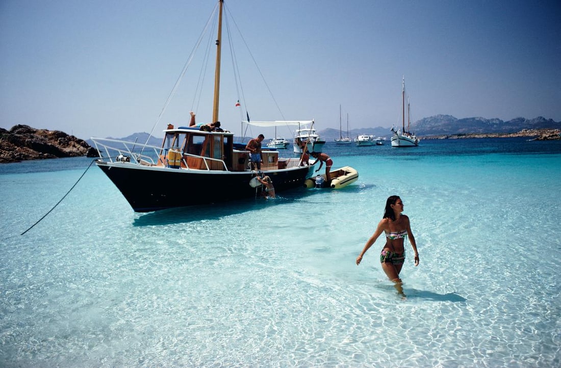 Slim Aarons 'Yachting Trip' 1967 Official Limited Estate Edition: 1967 (printed later): Title: Slim Aarons 'Yachting Trip' 1967 Official Limited Estate Edition: 1967 (printed later) Description: Yachting Trip' Selvaggia Borromeo wades ashore from her yacht during a holiday on the Costa S