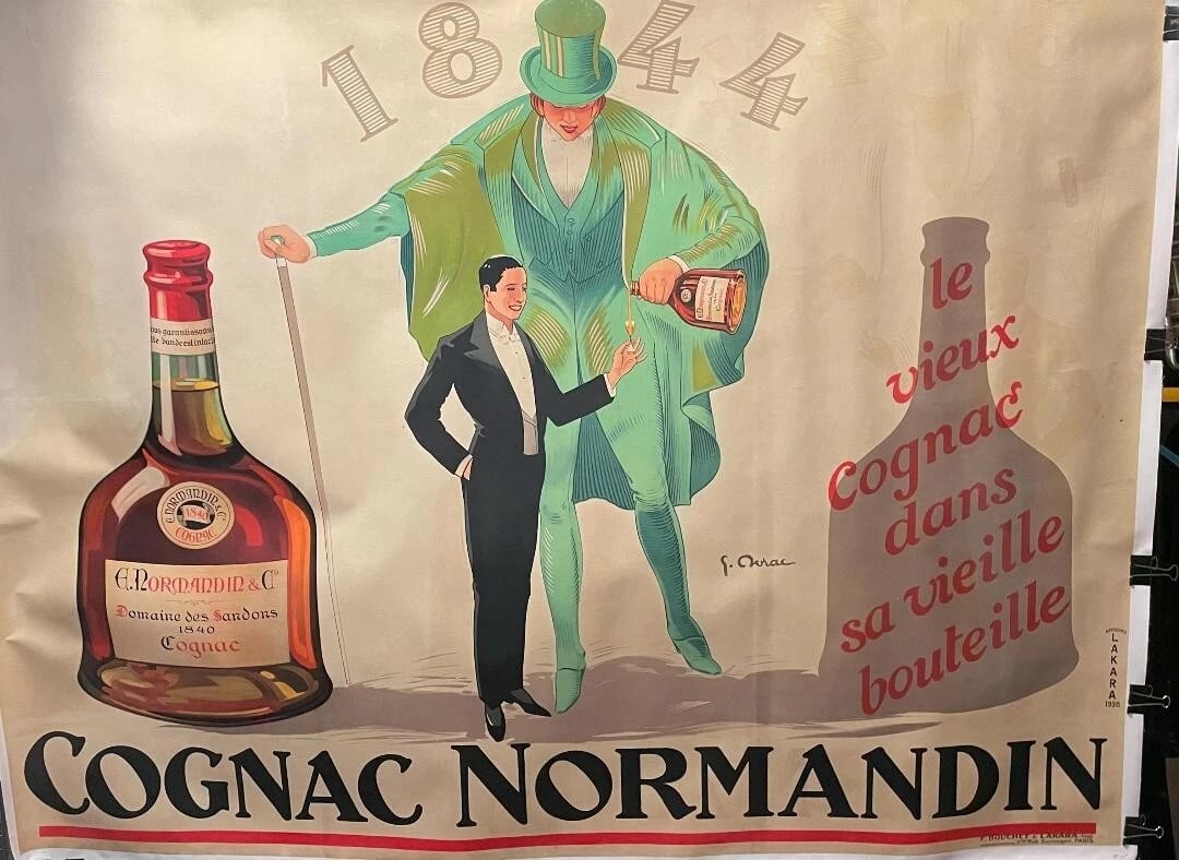 Original Vintage 1928 "Cognac Normandin" Poster Linen Backed: Title: Original Vintage 1928 "Cognac Normandin" Poster Linen Backed Description: Cognac Normandin is an exceptional poster using an exaggerated sized man clad in green pouring cognac into a glass. The