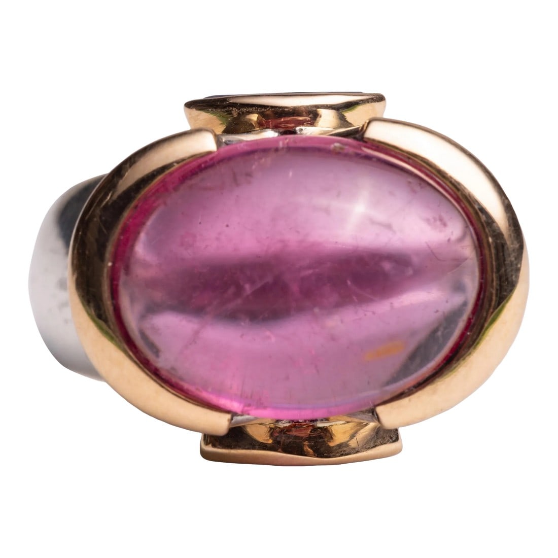 1990s Large Pink Tourmaline Dome Ring With Tanzanite: This is part of Chairish's Fine Jewelry assortment. A spectacular large pink tourmaline cabochon dome ring set in 18K gold. It is flanked by two marquise cut tanzanite stones also set in 18K gold.