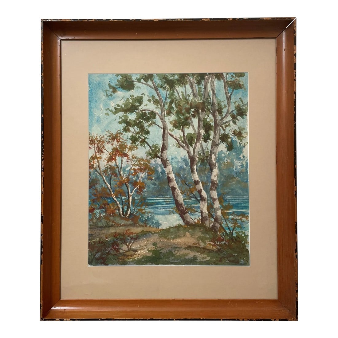 Watercolor Landscape by E. Lumley: A beautifully painted landscape highlighting trees against a serene blue lake. Condition: Original Condition Unaltered; Some Imperfections; Painting is in excellent condition. Finish on frame is