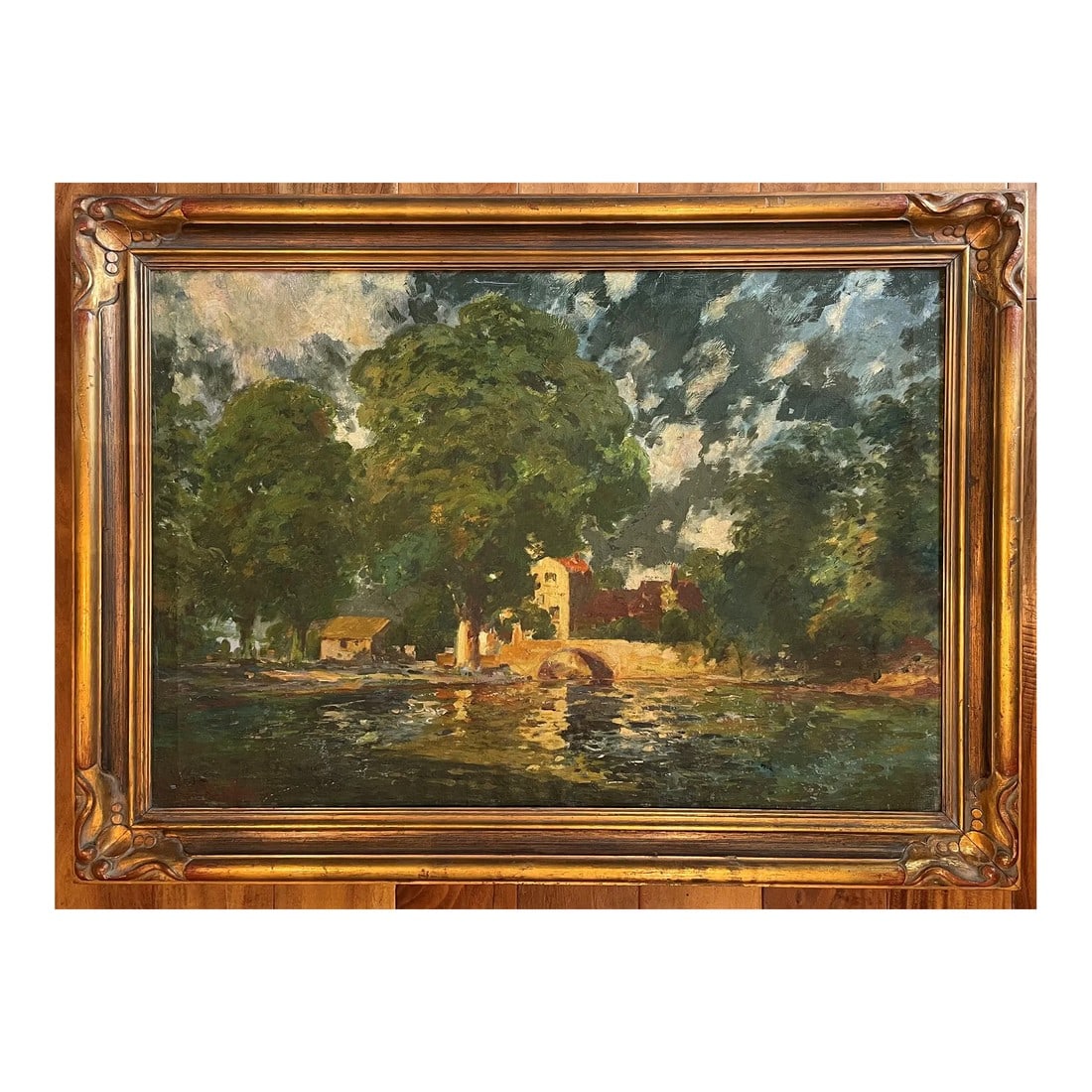 European Lake Landscape, Vintage Oil Painting: Stunning painting of a quaint bridge, building, and lush trees with dappled sunlight at the edge of a lake. Rich patina and texture with visible brush strokes. Beautifully carved giltwood frame with s