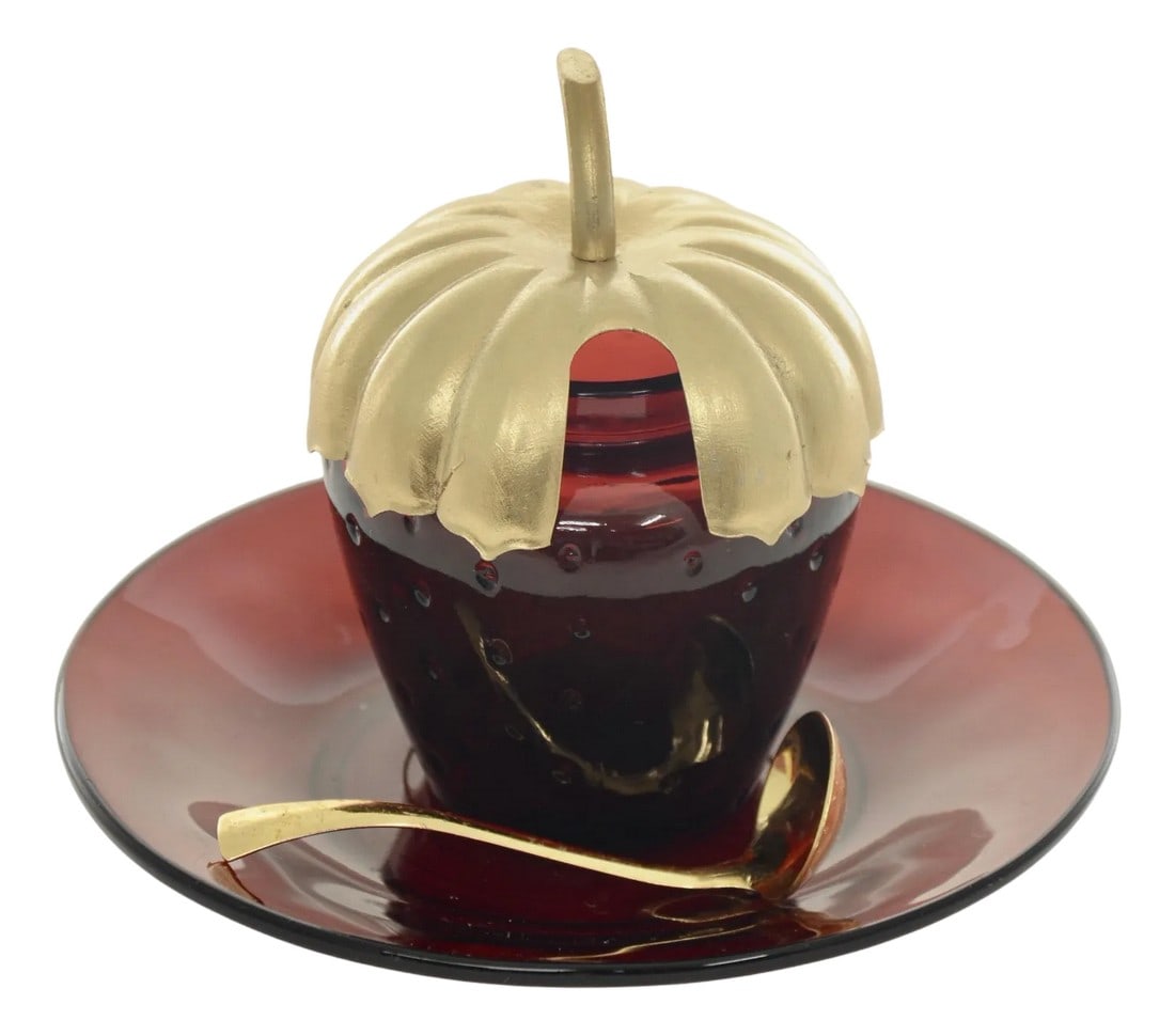 Ruby Red Jelly Serving Set - 4 Pieces: Vintage ruby red glass jelly or condiment jarl in a strawberry shape with a ruby under plate topped by a gold lid and matching spoon. Gold lid and spoon should be hand washed with mild soap and soft c