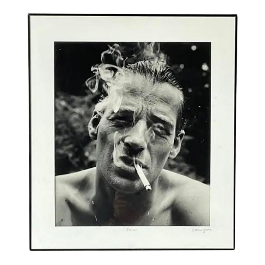Lance Evans Black and White Photograph Titled "Pascal": A striking and emotionally charged 1980s black and white photographic portrait by Lance Evans, titled "Pascal". Image captures a shirtless man mid-inhale, a cigarette hanging from his lips as plumes