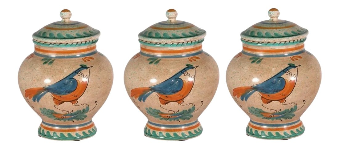 1990s Italian Hand Painted Ceramic Canister - a Pair: Hand painted ceramic canister featuring a right facing bird in ivory, blue, green, and gold colors. Hand made items may vary in size, color and pattern. Italy Can be a great gift for Christmas. Condit