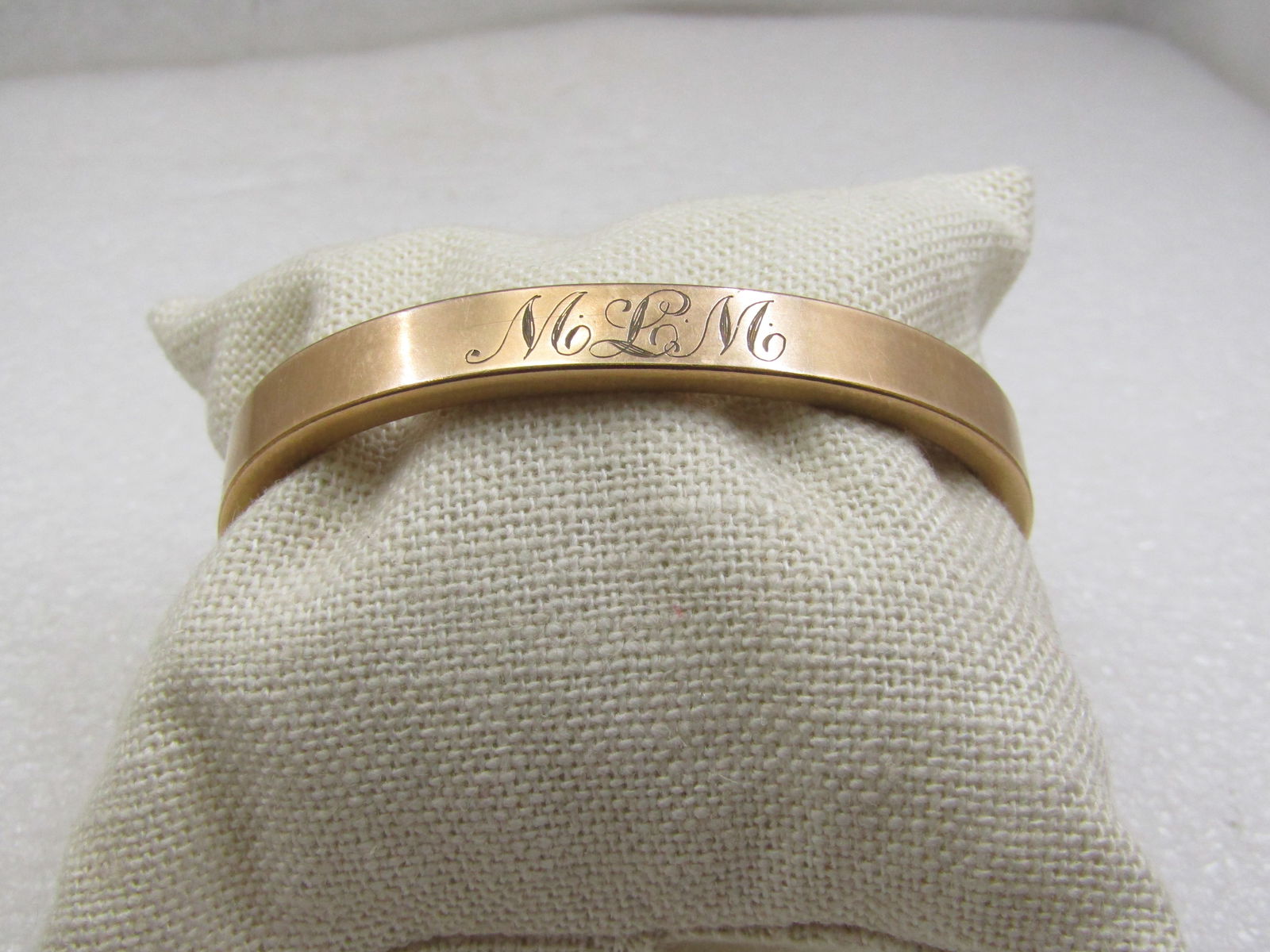 Antique Hinged 10kt Gold Filled Bangle Bracelet, Engraved MLM, Signed Bates & B. 6.75": Antique Hinged 10kt Gold Filled Bangle Bracelet, Engraved MLM, Signed Bates & B. which is Bates & Bacon, 6.75". 14.63 grams. The gold has been tested and tests as 10kt gold filled. It is appx. 7.5mm