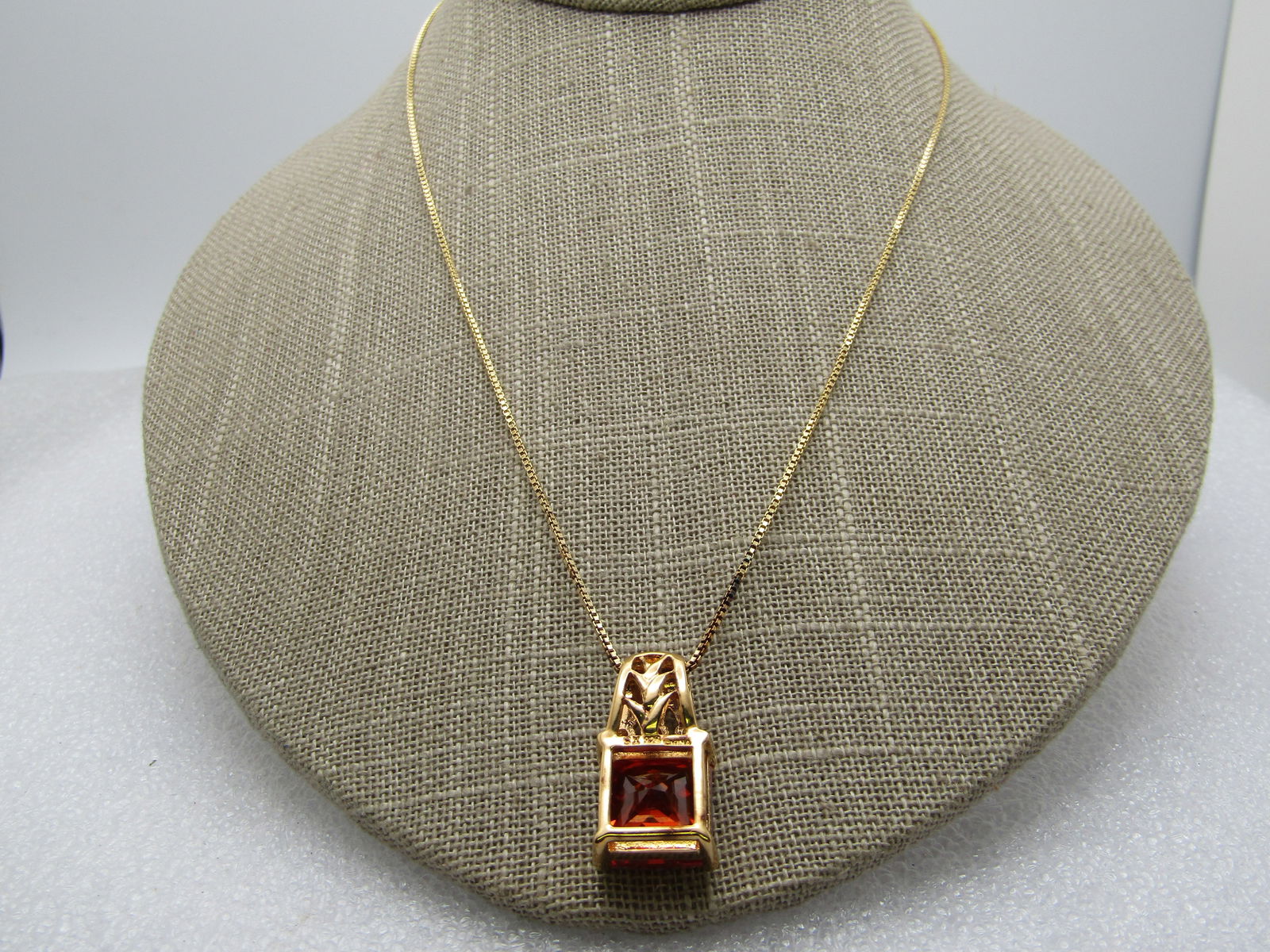 Sterling Vermeil Orange & Clear CZ Pendant, Technibond, Original Box, 18": Sterling Vermeil Orange & Clear CZ Pendant, Technibond, Original Box, 18". This has a nearly 1" long pendant with a decorative wide bail, three clear CZ stones and a square 12mm orange faceted CZ or