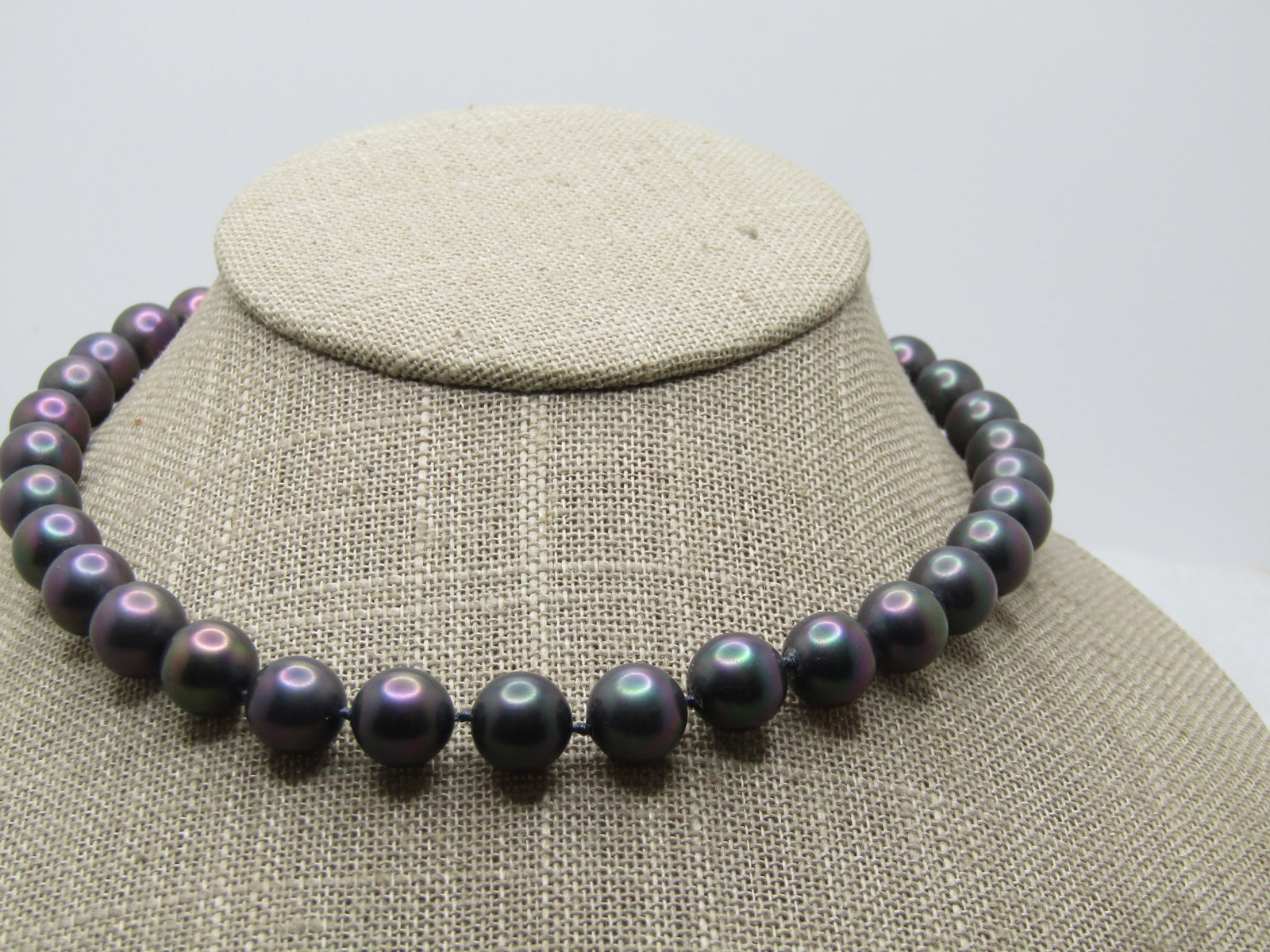 12kt G.F. Peacock Tahitian Pearl Necklace, Rhinestone clasp. 16", 1980's: 12kt G.F. Peacock Tahitian Pearl Necklace, Rhinestone clasp. 16", 1980's. The pearls are appx. 9mm in purchase/green/blue with a knot between each pearl. Cultured or created - unsure. They have a rhin