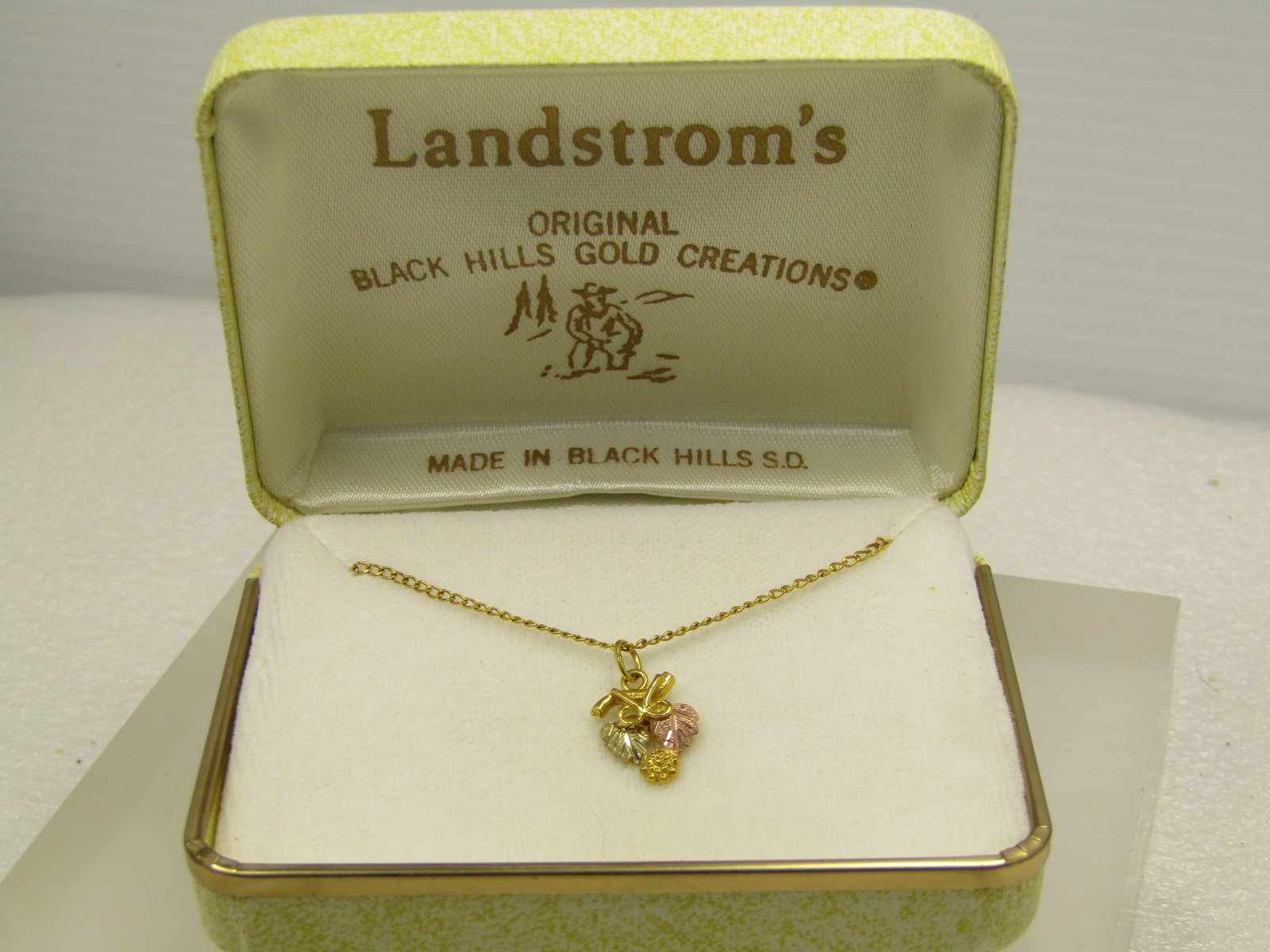Vintage 10kt & 12kt GF Black Hills Gold Necklace, 18", Landstrom's Original Box, 1980's-1990's: Vintage 10kt & 12kt GF Black Hills Gold Necklace, 18", Landstrom's Original Box, 1980's-1990's. This has a 10kt grape leaves and cluster style pendant and is marked 10kt, It is two-tone and signed