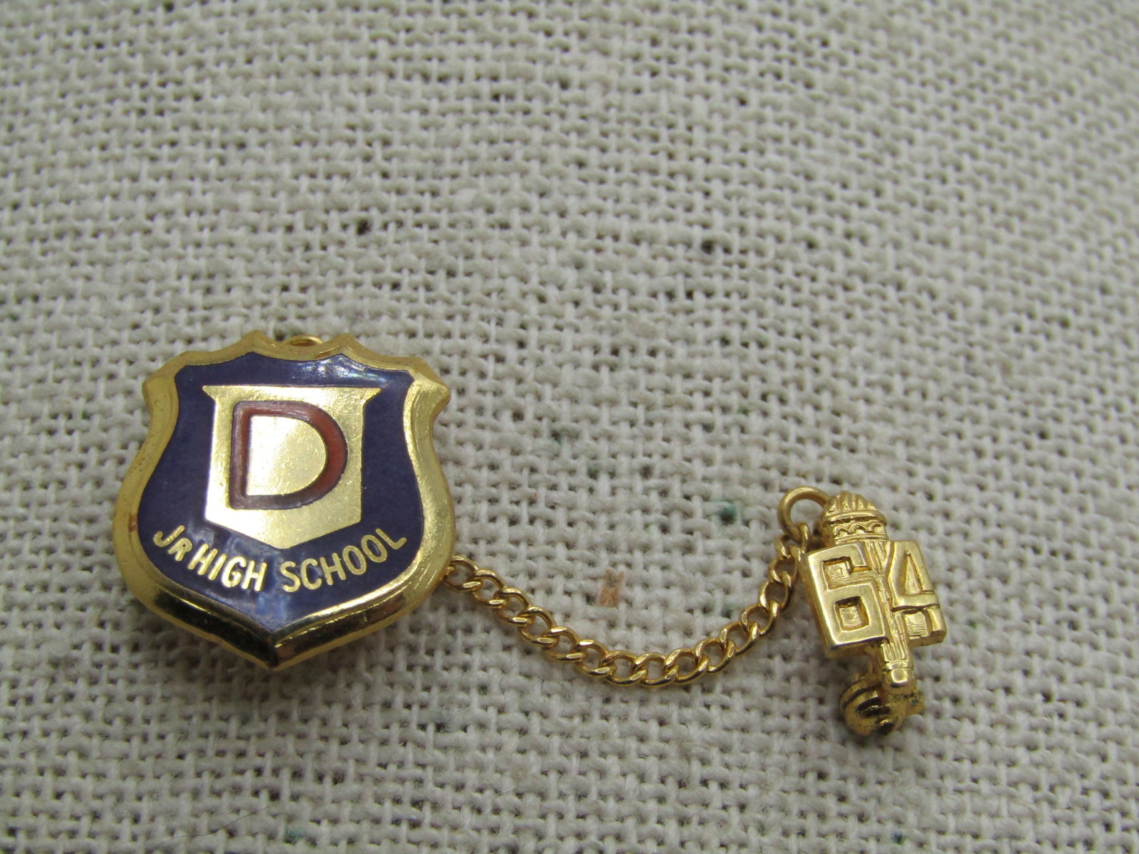 Vintage 1964 Danville Jr. High School Pin, 10kt G.F.: Vintage 1964 Danville Jr. High School Pin, 10kt G.F. This has a blue enameled background with a red D in the center. It is shield shaped and appx. 3/4" tall and 5/8" wide with a 1.5" chain and