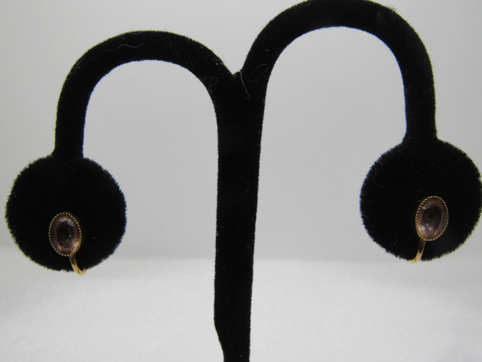 Vintage 12kt G.F. Pink Stone Earrings, Screwback, 1960's: Vintage 12kt G.F. Pink Stone Earrings, Screwback, 1960's. the stone is oval, cut pale pink glass that is appx. 7mm by 5.5mm set in a sawtooth bezel-setting. Signed CC on the screw. Light wear -