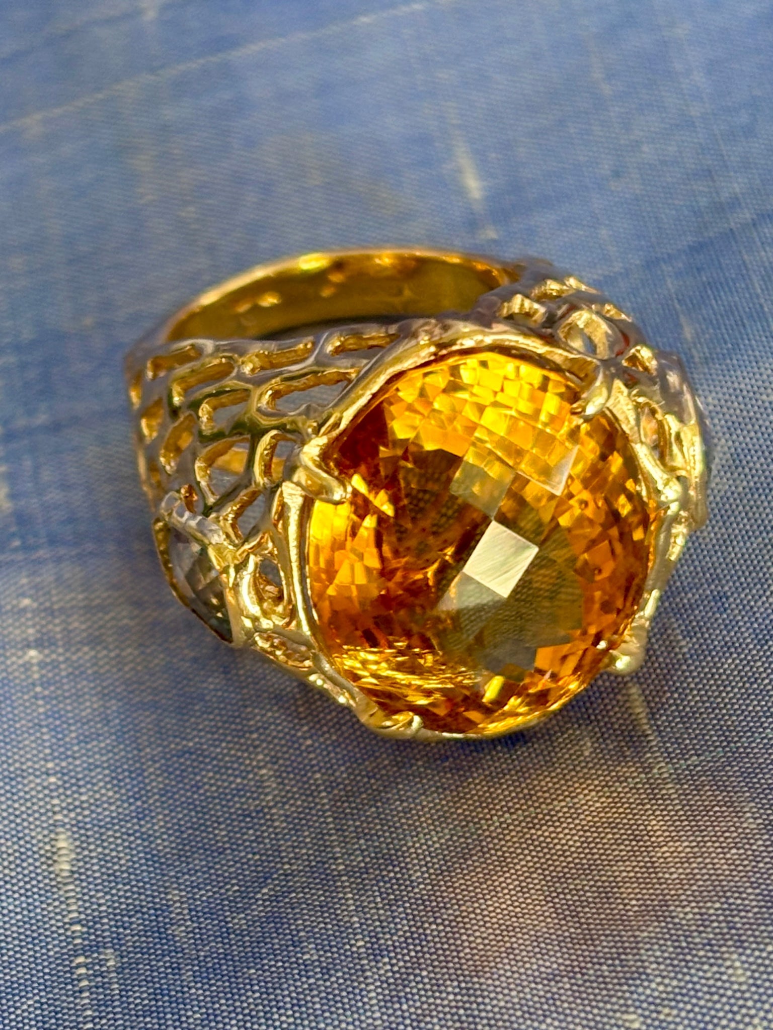 Knock out Citrine Ring: Title:Knock out Citrine Ring Description:This ring is dangerous. The citrine is the size of a big gum ball, and is mounted in a 14-Karat Gold setting like Sea Fan, but it speaks to power. Each side of