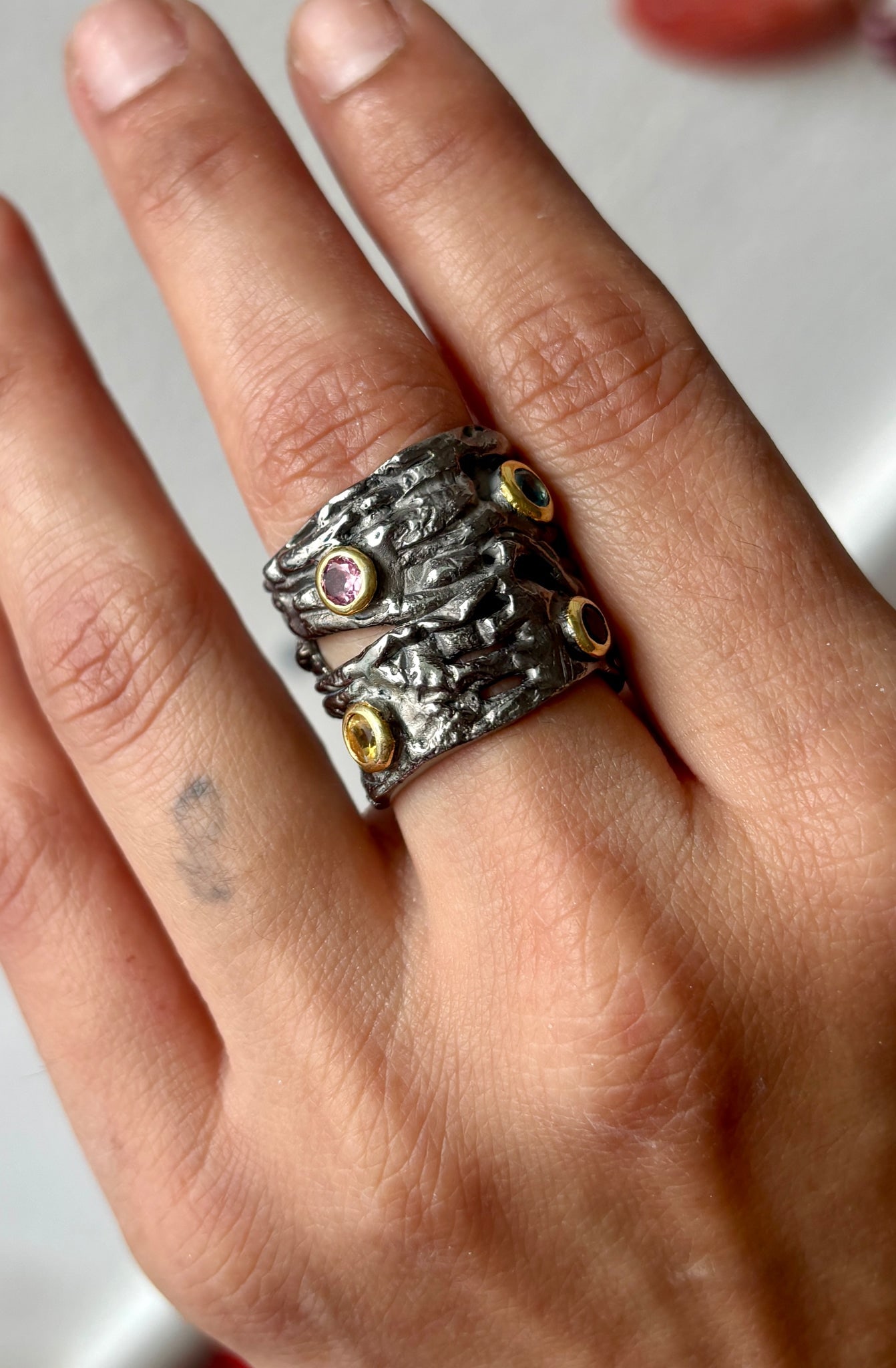 Sterling Finger Hugger Ring: Title:Sterling Finger Hugger Ring Description:Primitive kind of Seagrass ring set with Peridot, Pink Topaz, Citrines and Aquamarine. This Silver ring feels solid on the finger. Reserve: $360.00 Shippi