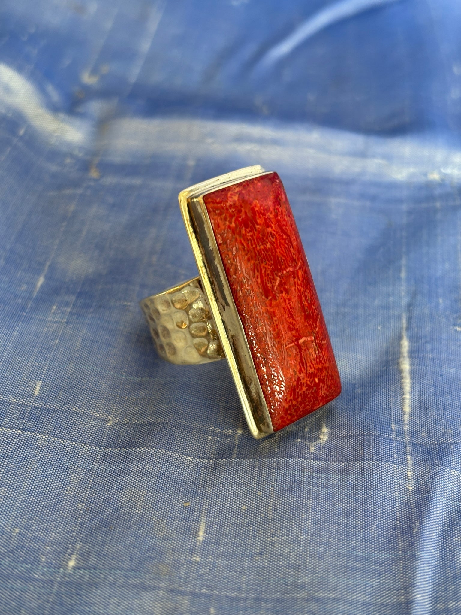 Contemporary Hammered, Coral Ring: Title:Contemporary Hammered, Coral RingDescription:Clean-cut design in this fun, hand-hammered ring. Apple Coral cut in a rectangular shape and mounted into a hammered sterling ring. Comfortable and