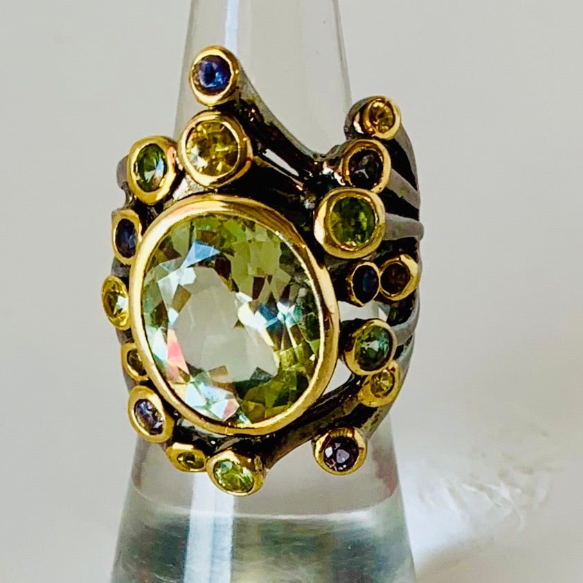 Low Profile Aquamarine Ring: Title:Low Profile Aquamarine RingDescription:Low-setting, handsome wartery-blue. Ring is made of Sterling Silver with 18-Karat Gold accents. Extremely comfortable for everyday wear, this fun ring