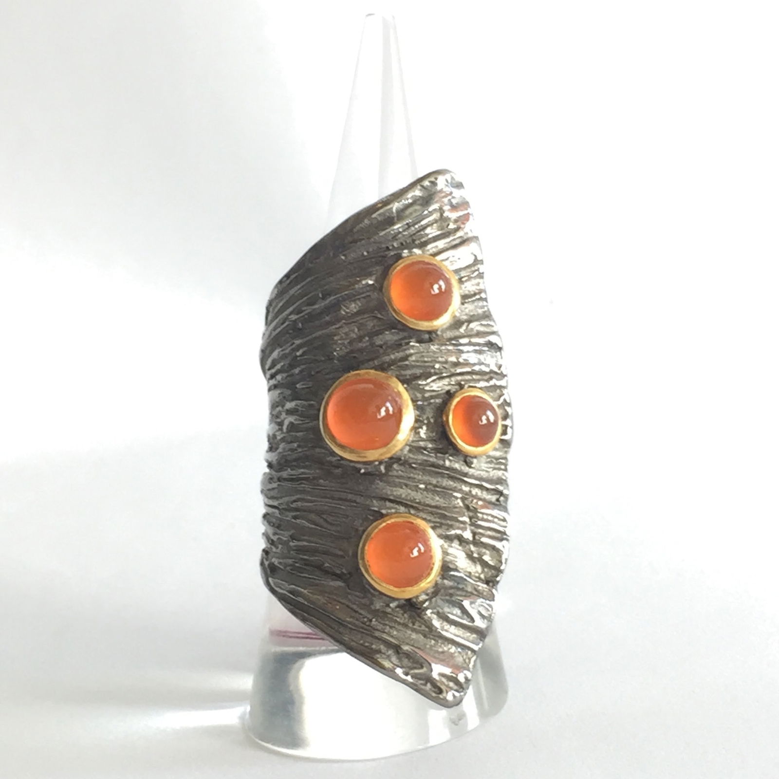 Fishtail Carnelian Ring: Title:Fishtail Carnelian RingDescription:Comfortable Sterling Silver ring for everyday. It is shaped like a fishtail and set with cabochon Carnelian. Size 7. Reserve: $280.00 Shipping:Domestic: