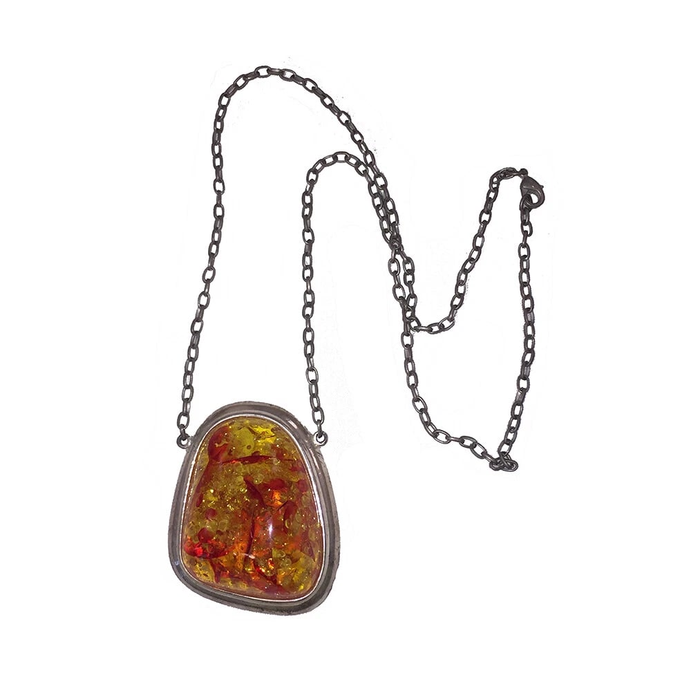 Simulated Baltic Amber Silver Tone Nugget Necklace: Title:Simulated Baltic Amber Silver Tone Nugget NecklaceDescription:Simulated Baltic Amber Silver Tone Nugget Necklace. Pendant measures 2 1/4" long and 2" wide. Necklace measures 24" long. Closes
