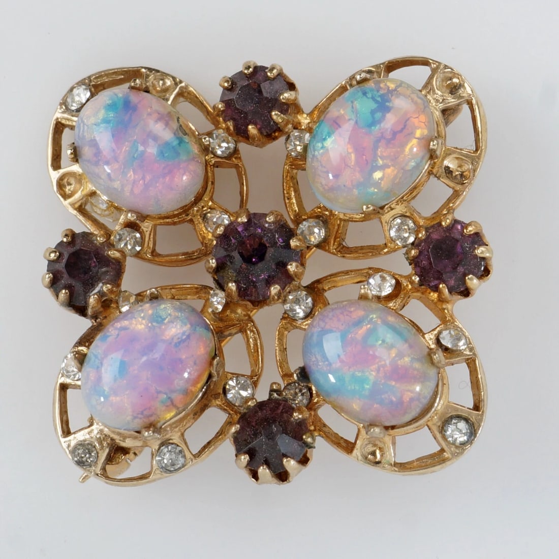 1950s Brooch/Pin Garnet and Faux Opals: Title:1950s Brooch/Pin Garnet and Faux Opals Size:15/16 in x 15/16 in. Description:A very pretty vintage pin featuring faux opal cabochons and small round garnets mounted in a yellow gold tone open fr