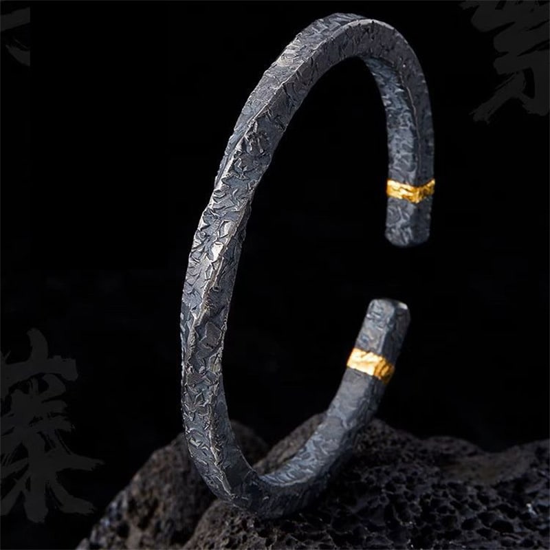Forged Midnight Bangle – Textured Titanium Steel with Gold Accents: Title:Forged Midnight Bangle – Textured Titanium Steel with Gold AccentsDescription:Crafted from durable titanium steel, this bangle features a rugged hammered texture contrasted by refined