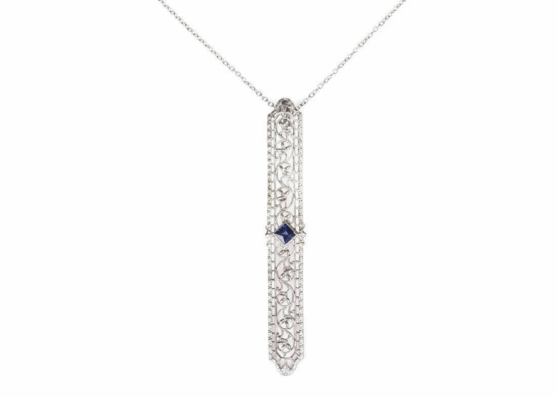 Art Deco 14 kt White Gold Filigree Necklace with Blue Sapphire: Title:Art Deco 14 kt White Gold Filigree Necklace with Blue Sapphire Description:Handmade brass bell with ship's wheel handle. Dimensions: 3.43" W x 6.5" H Reserve: $692.00 Shipping: Domestic: Flat-ra