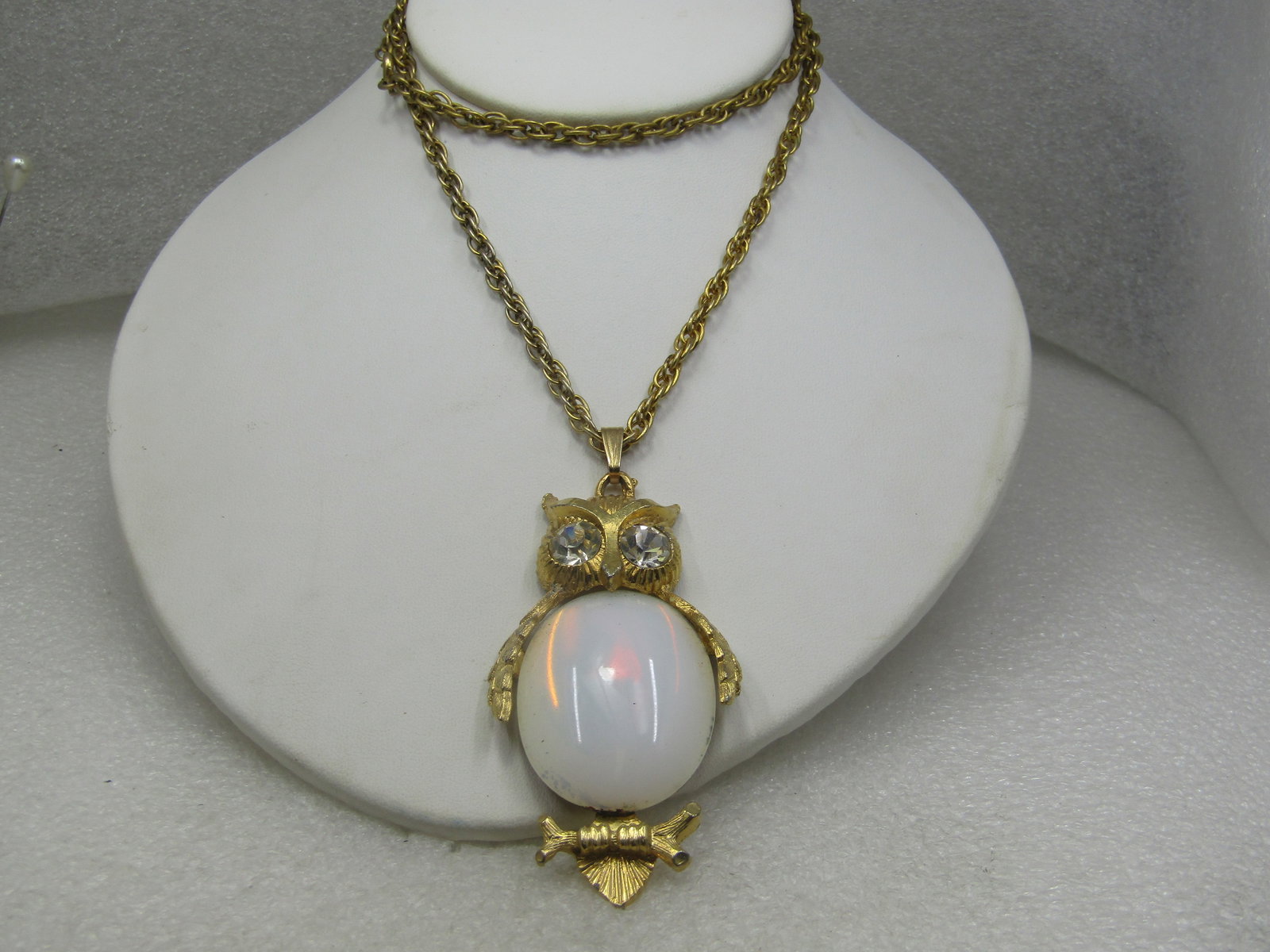 Vintage White Glass & Rhinestone Owl Necklace, 1960's, 24": Vintage Glass & Rhinestone Owl Necklace, 1960's, 24" long rope style chain, gold tone with large 8mm clear crystal rhinestone eyes and a glass opaque white body which is appx. 1.75" logn and 1.25