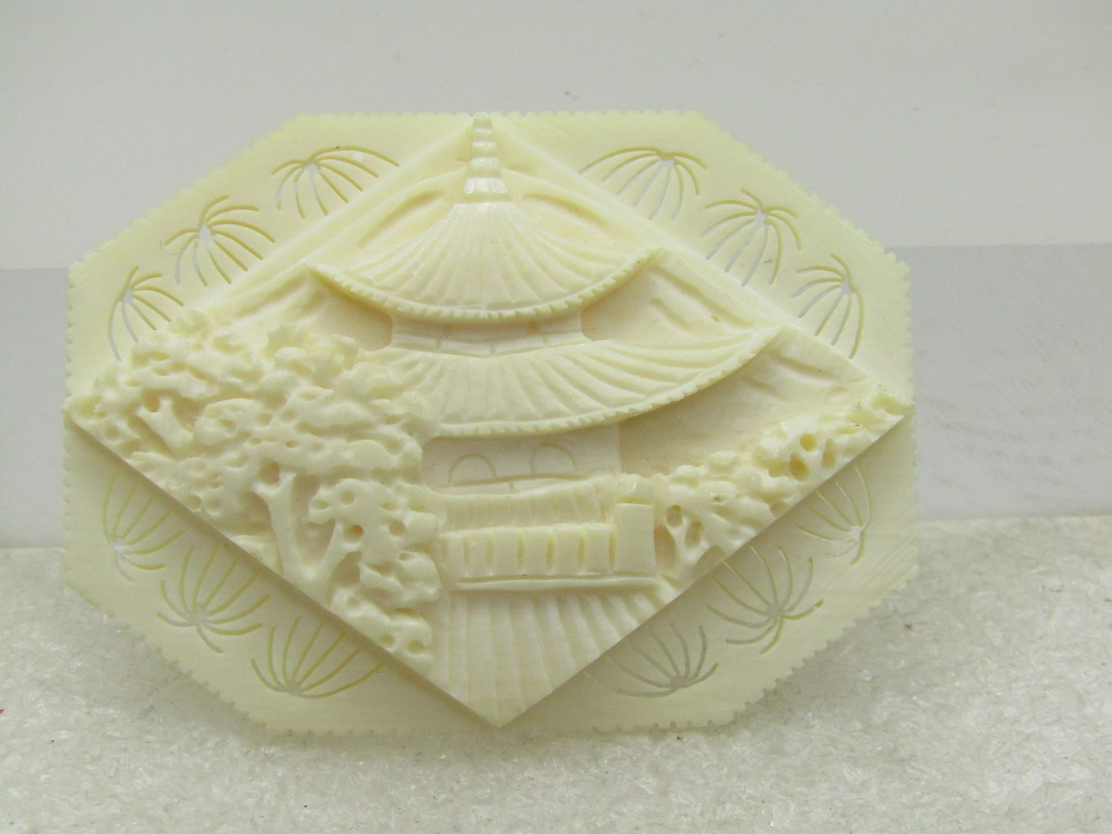 Sterling Carved White Pagoda Brooch, Tiered, Trombone Clasp, 1930's-1940's: Sterling Carved White Pagoda Brooch, Tiered, Trombone Clasp, 1930's-1940's. 2.25" wide and 1.75" tall. Tiered with thin carved designs around the edges of the base that look like fireworks and