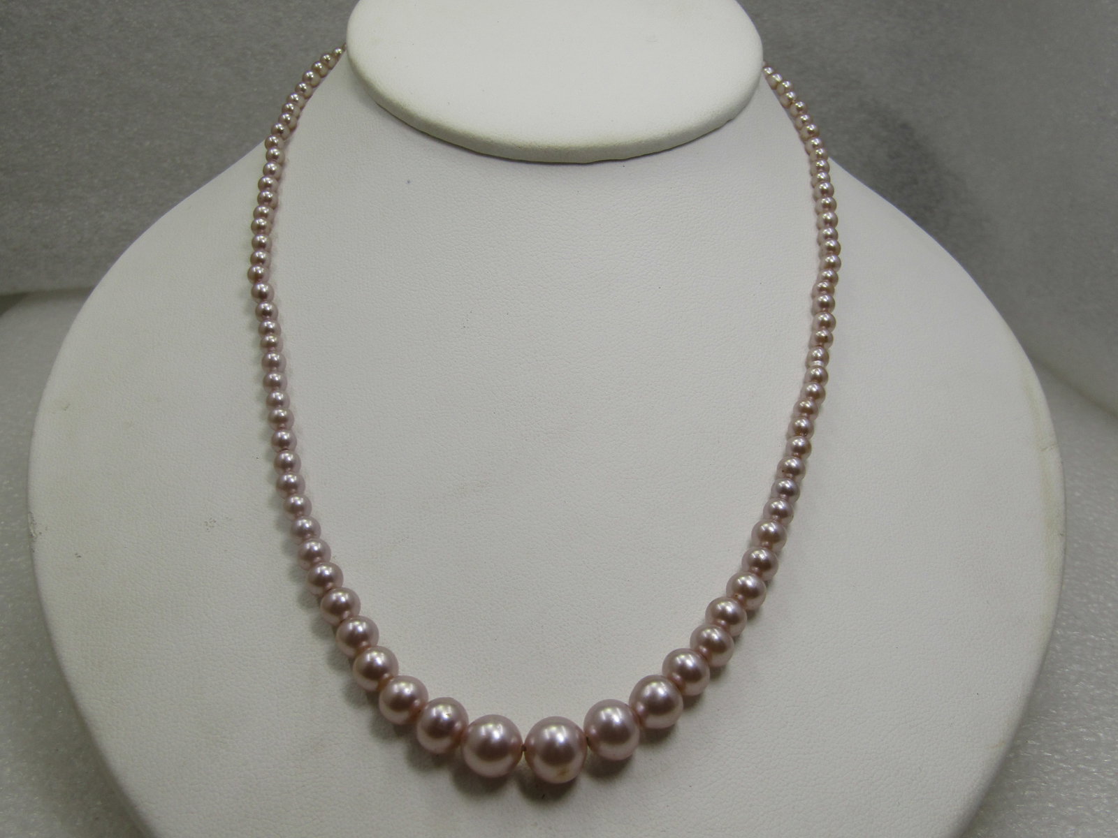 Vintage Graduated Faux Pearl Necklace, 17.5" Mid-Century: Vintage Graduated Faux Pearl Necklace, 17.5" Mid-Century. The pearls are a blush colored and graduated from size 2.5mm to 7.5mm with a domed button pearl on the box clasp. That pearl is more white tha