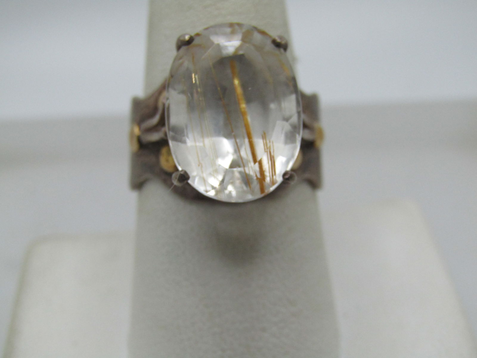 Vintage Sterling Rutilated Quartz Ring, Sz. 8, Appx. 10+ TCW, Signed McM: Vintage Sterling Rutilated Quartz Ring, Sz. 8, Appx. 10+ TCW, Signed McM. This has gold round accents on each side of the stone on the top of the band. They test positive as 10kt. Mod design with