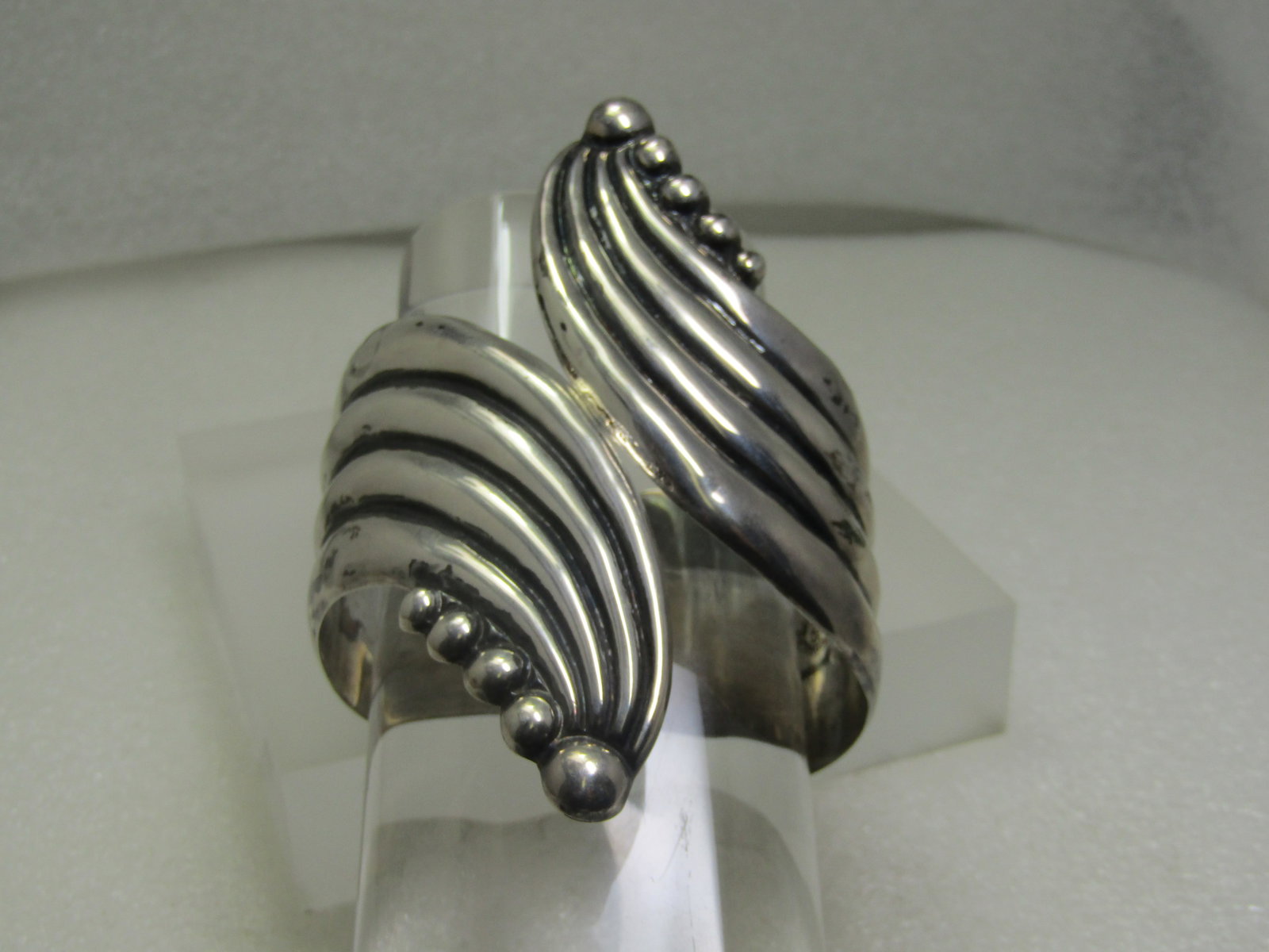 Vintage Sterling Wide Bypass Clamper Bracelet, Taxco, Mexico, 6.75": Vintage Sterling Wide Bypass Clamper Bracelet, Taxco, Mexico, 6.75". This is appx. 3-7/8"3 from the bead point on each side of the bracelet and each band is appx. 1.5" as it sits on the upper sides of